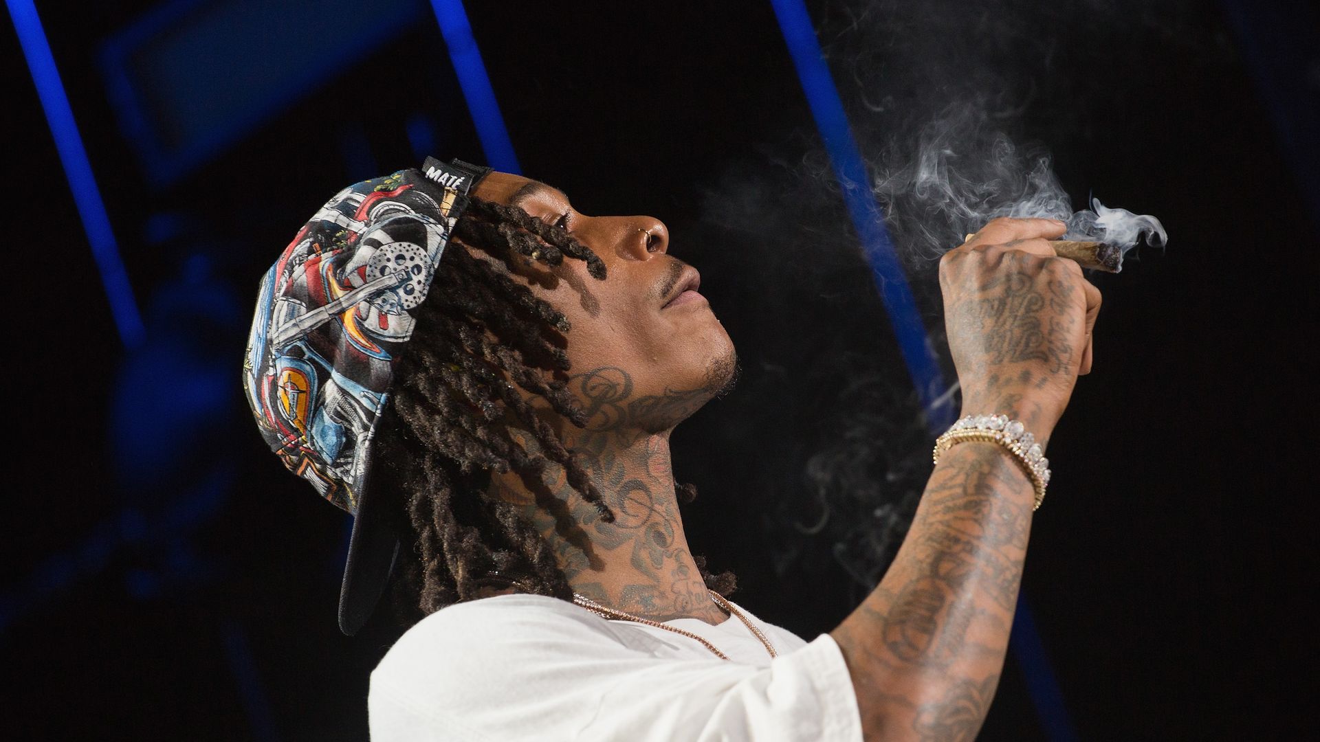 Rapper Wiz Khalifa performs onstage during the 'Dazed & Blazed Summer 2018 Tour' at Austin360 Amphitheater while smoking a blunt on stage