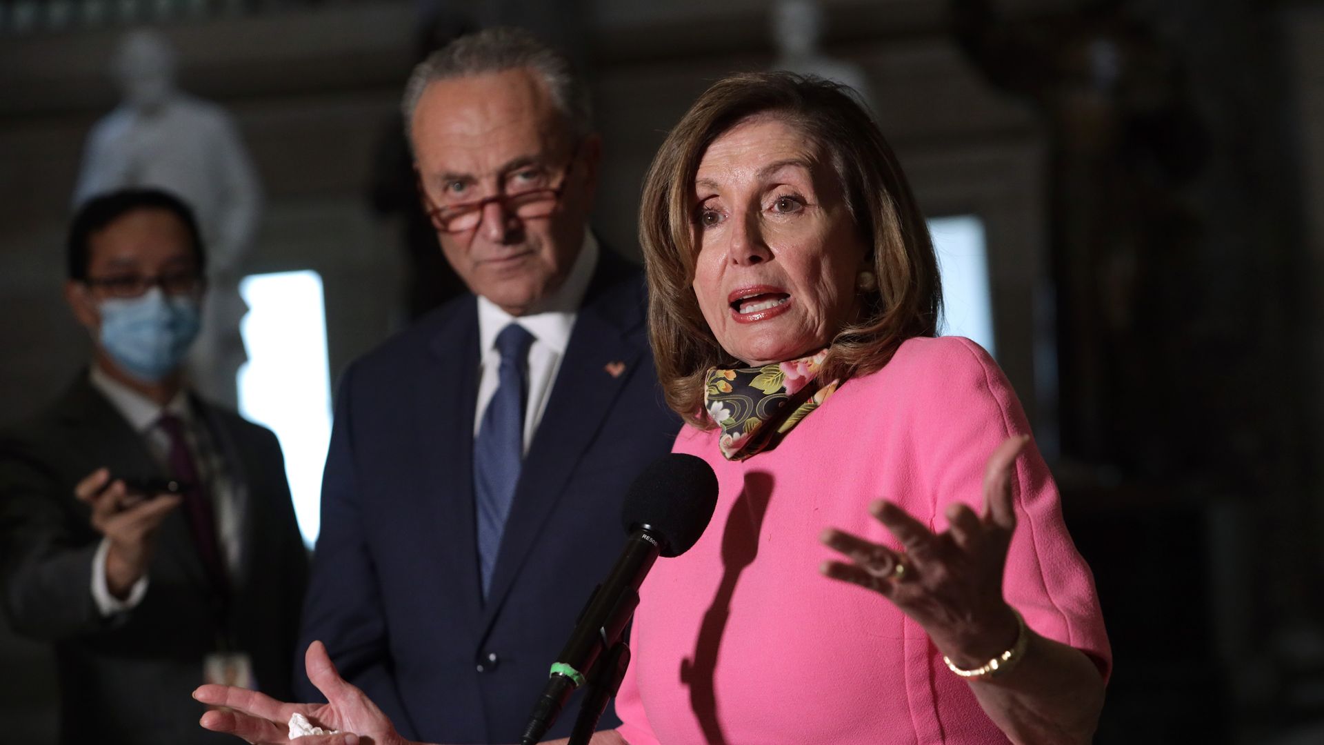 Nancy Pelosi and Schumer stand in front of reporters 