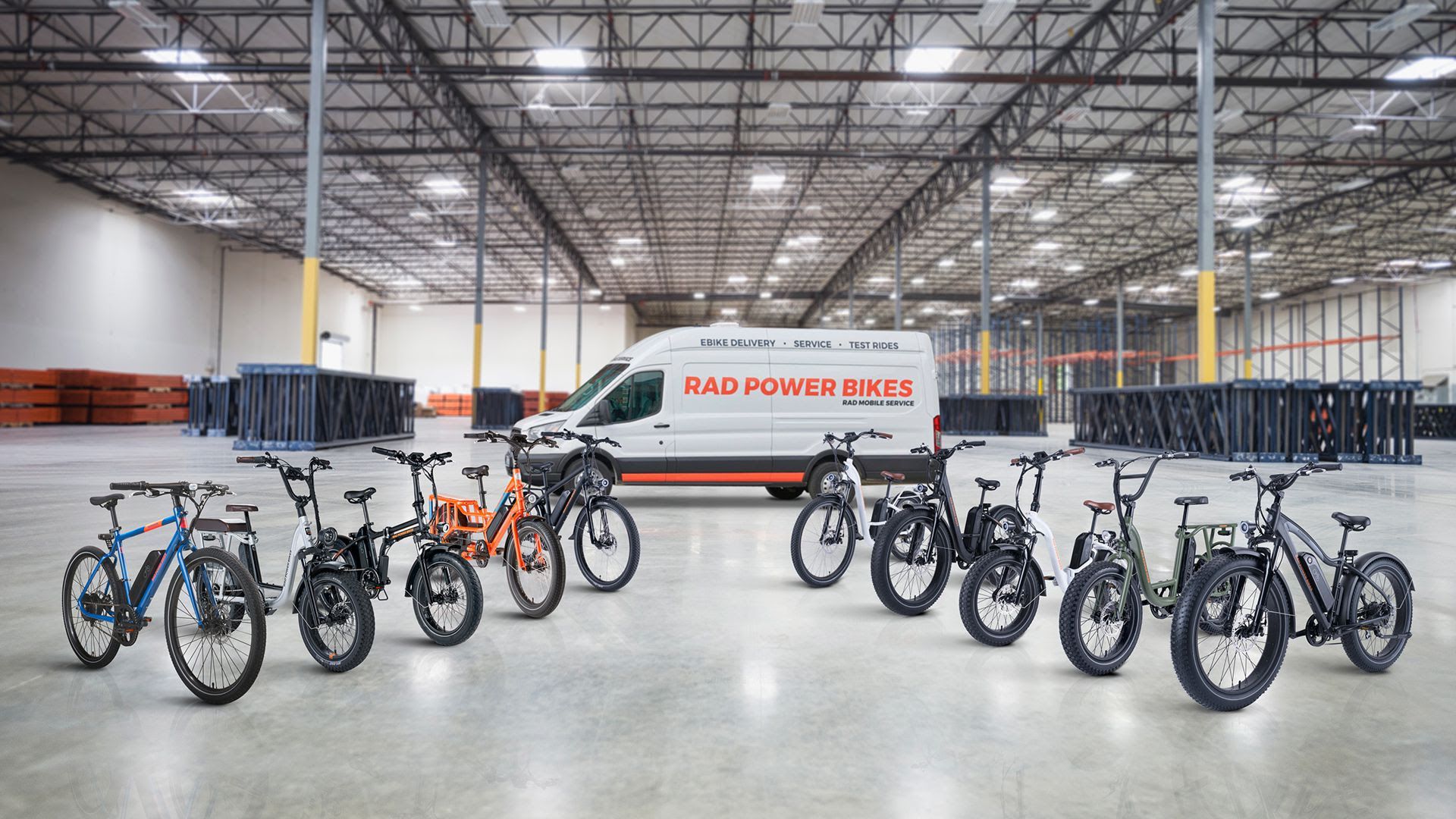 Seven Rad Power bikes lead to the company's white and orange van.