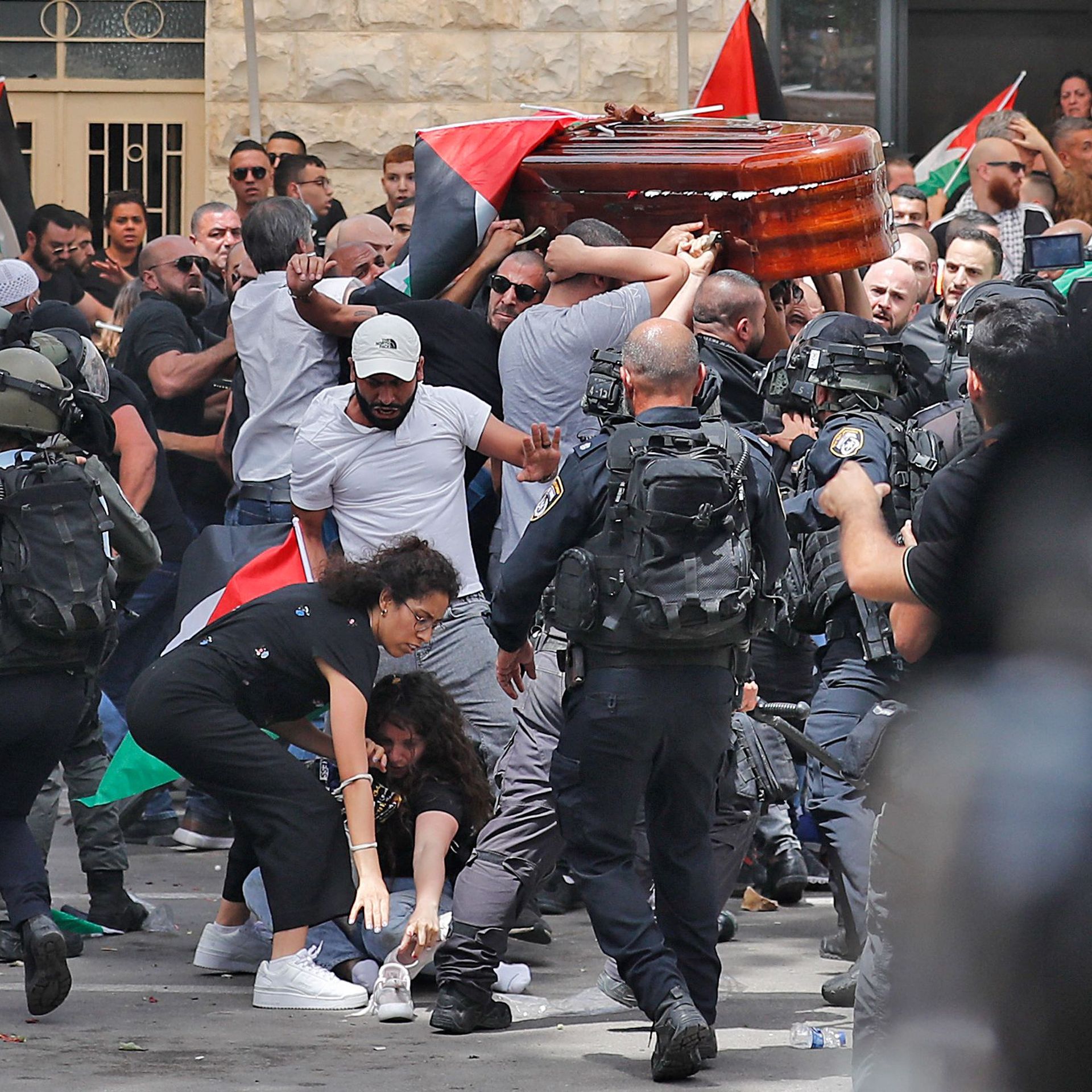Israeli police beat mourners carrying Shireen Abu Akleh's casket outside a hospital in Jerusalem. Photo: Ahmad Gharabli/AFP via Getty Images
