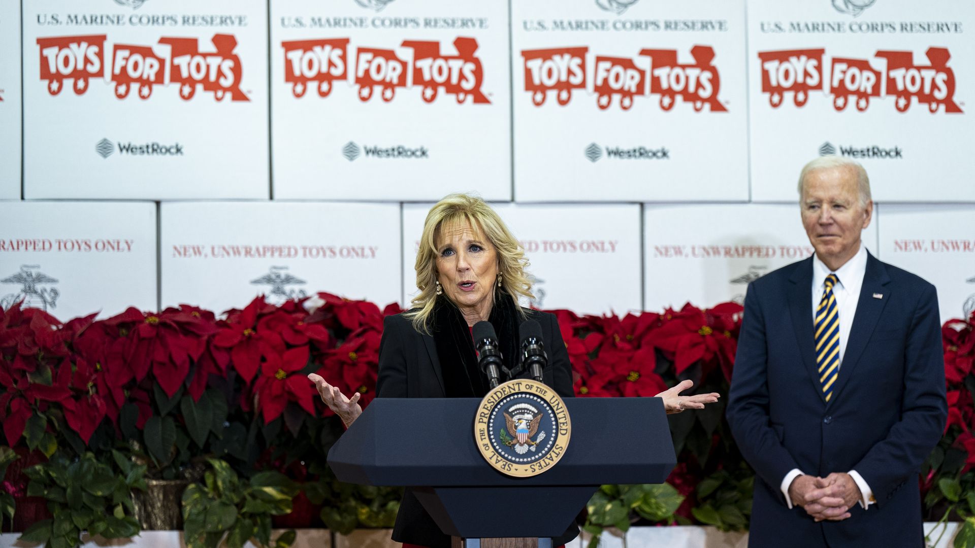 First Lady Jill Biden speaks at a Marine Corps Reserve Toys for Tots event with US President Joe Biden, right, at Joint Base Myer-Henderson Hall in Arlington, Virginia, US, on Monday, Dec. 12.