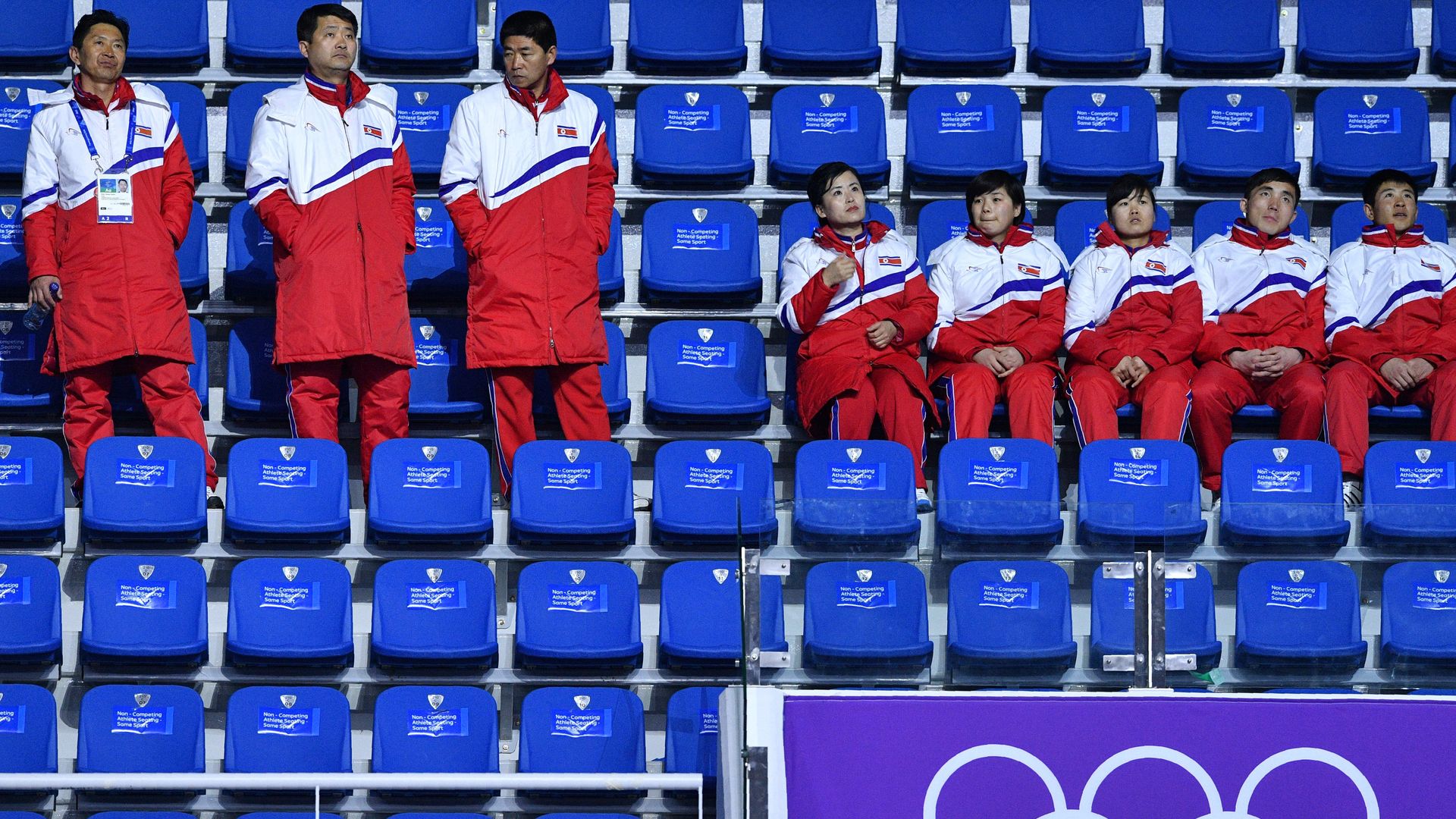 Members of the North Korean delegation look on from the stands 