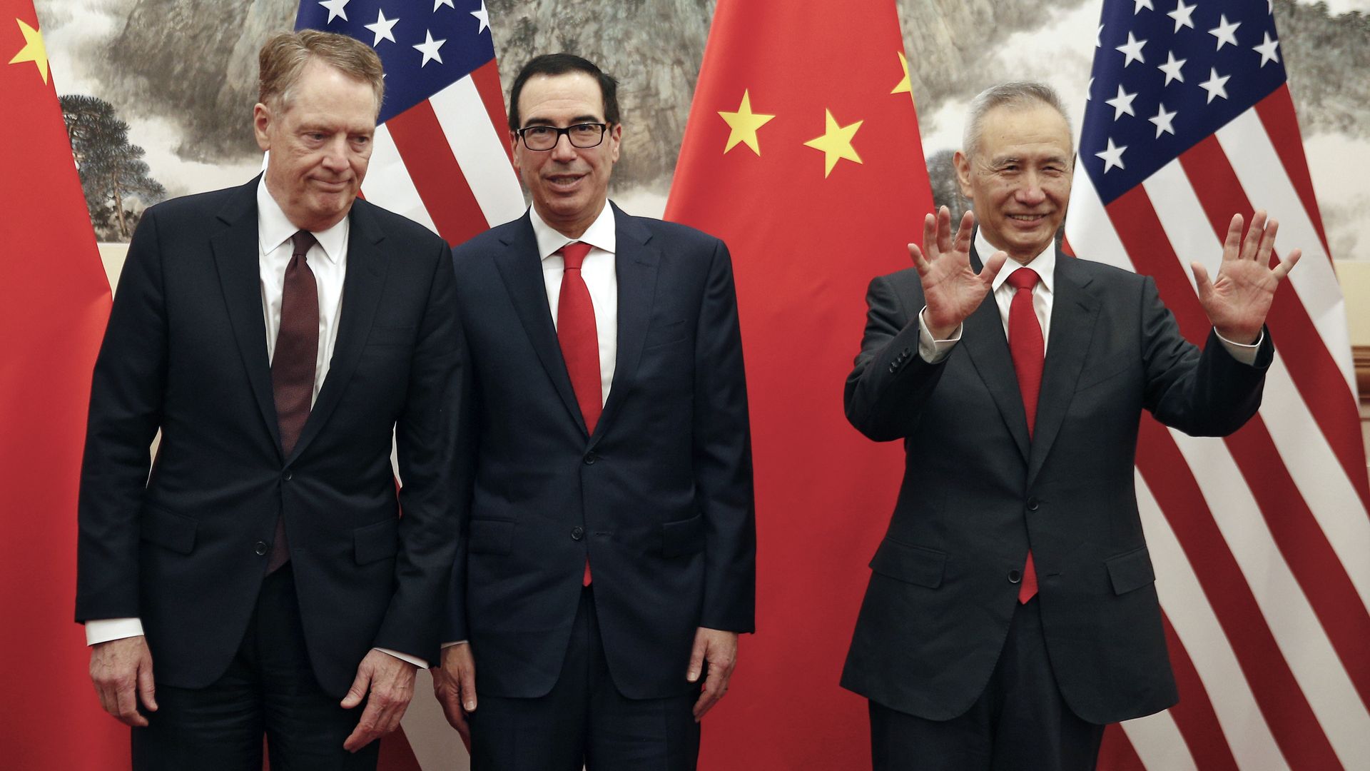 Chinese Vice Premier Liu He (R) gestures as US Treasury Secretary Steven Mnuchin (C) chats with his Trade Representative Robert Lighthizer.