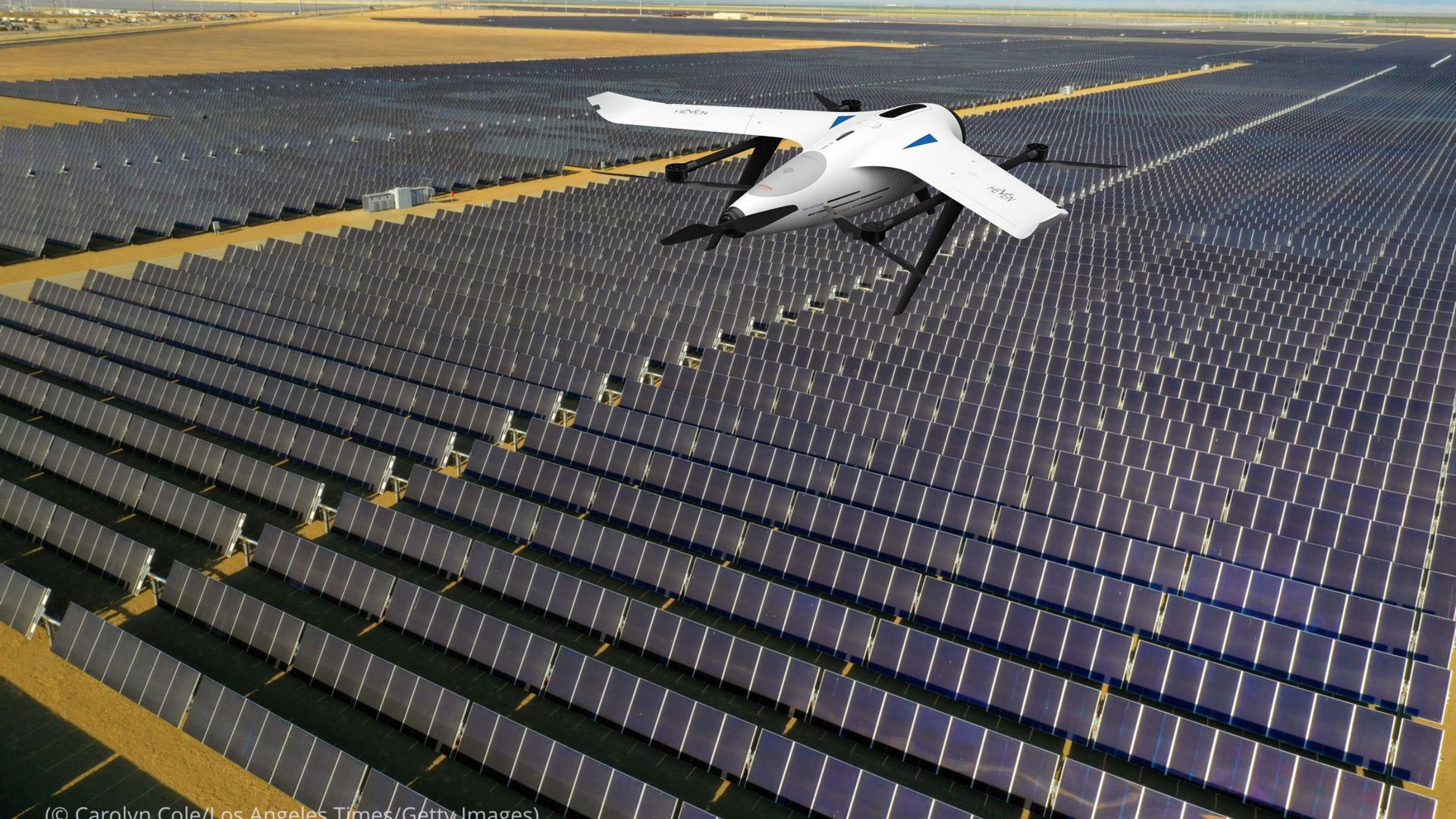 Image of a large hydrogen-powered drone flying over a large solar panel field