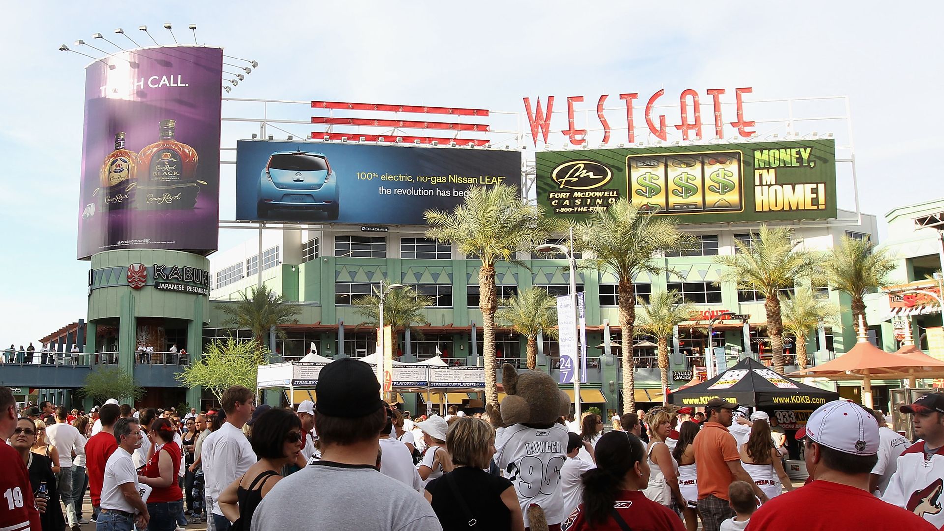 A shopping and entertainment center filled with people with a large sign above it that reads Westgate.