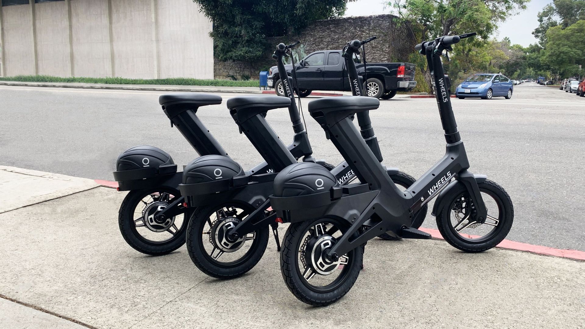 Image of helmets locked on the rear fender of Wheels bikes