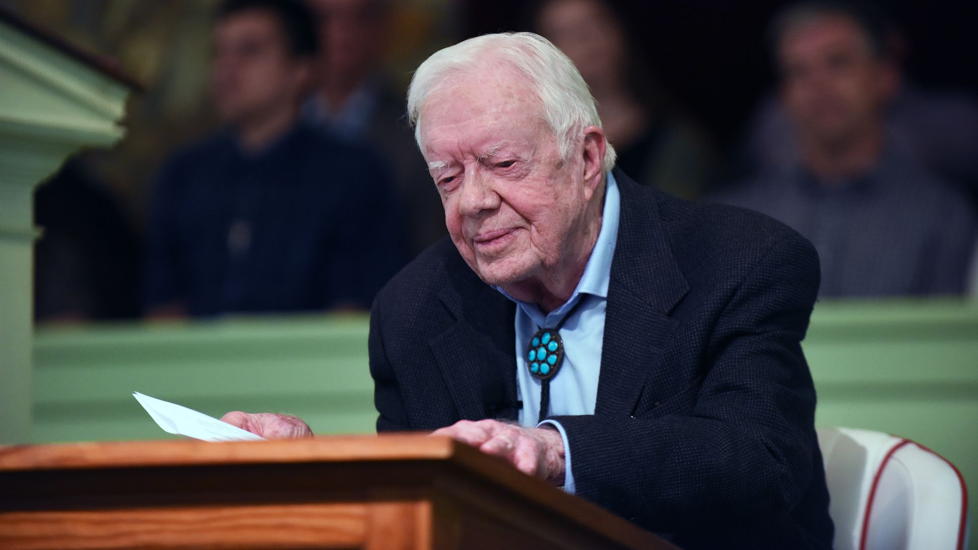 Jimmy Carter stands at a podium 