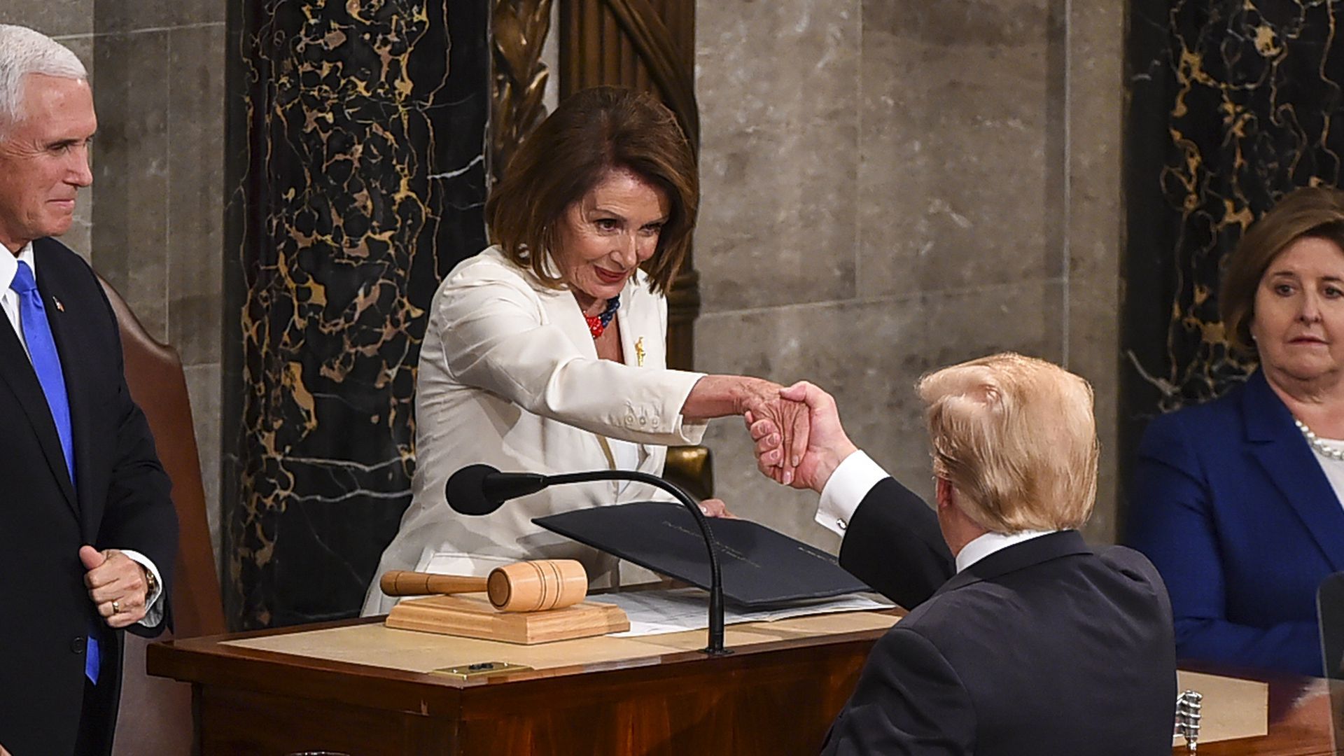 House Speaker Nancy Pelosi greets President Trump.