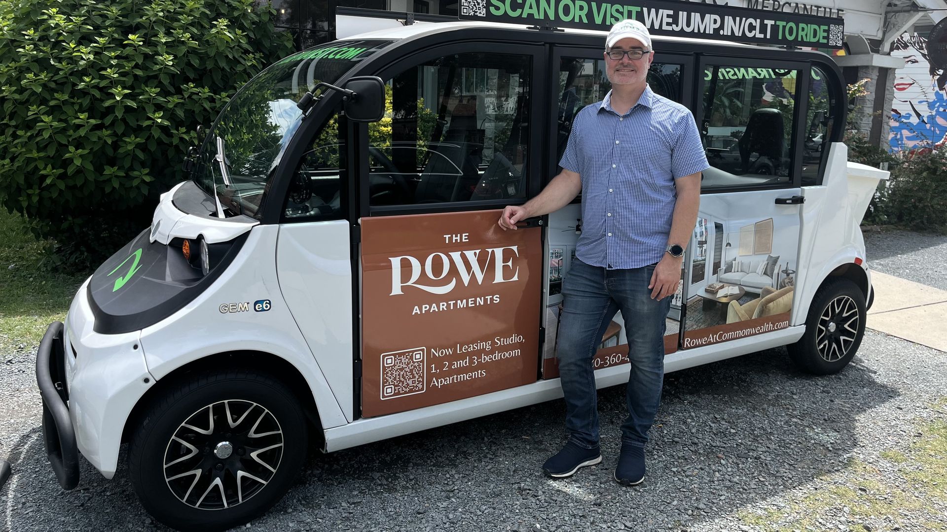 Justin stands in front of a microtransit vehicle