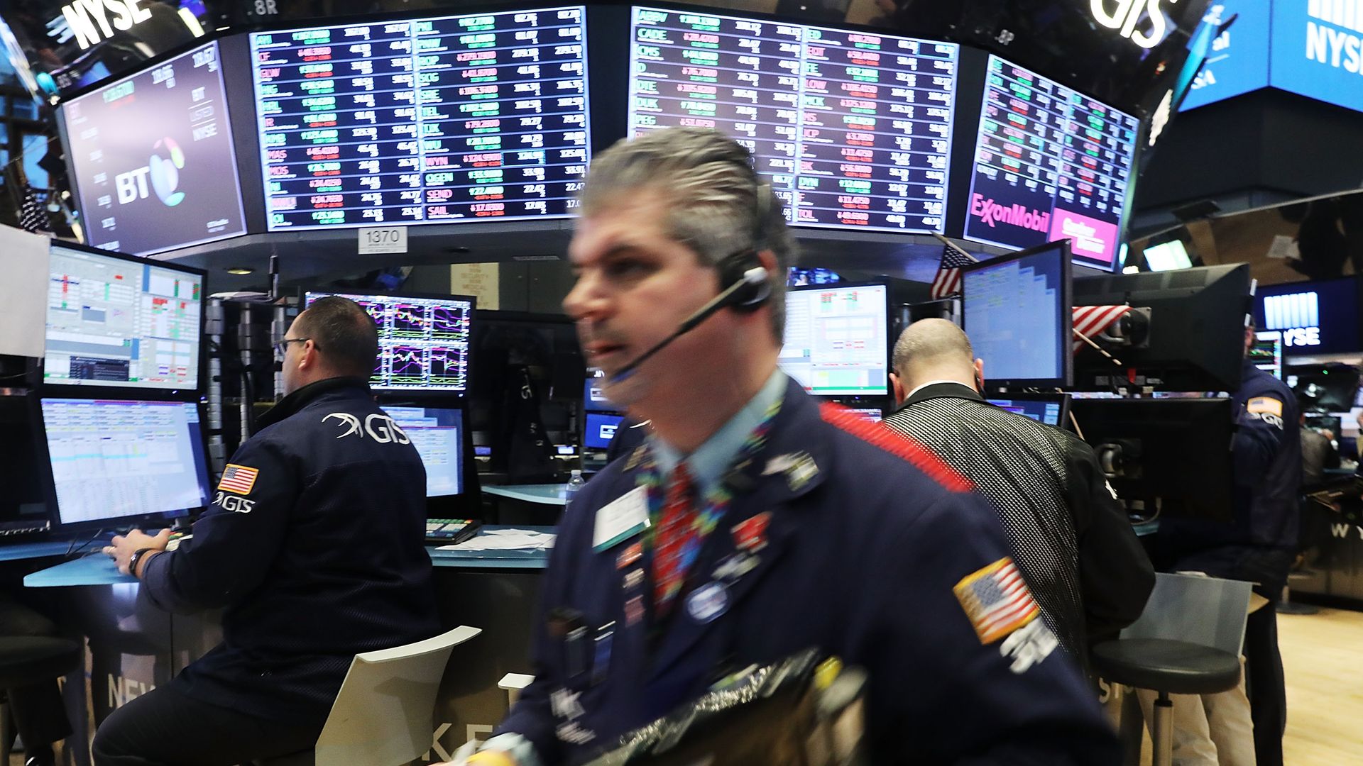 Brokers run around on the Wall Street stock exchange floor