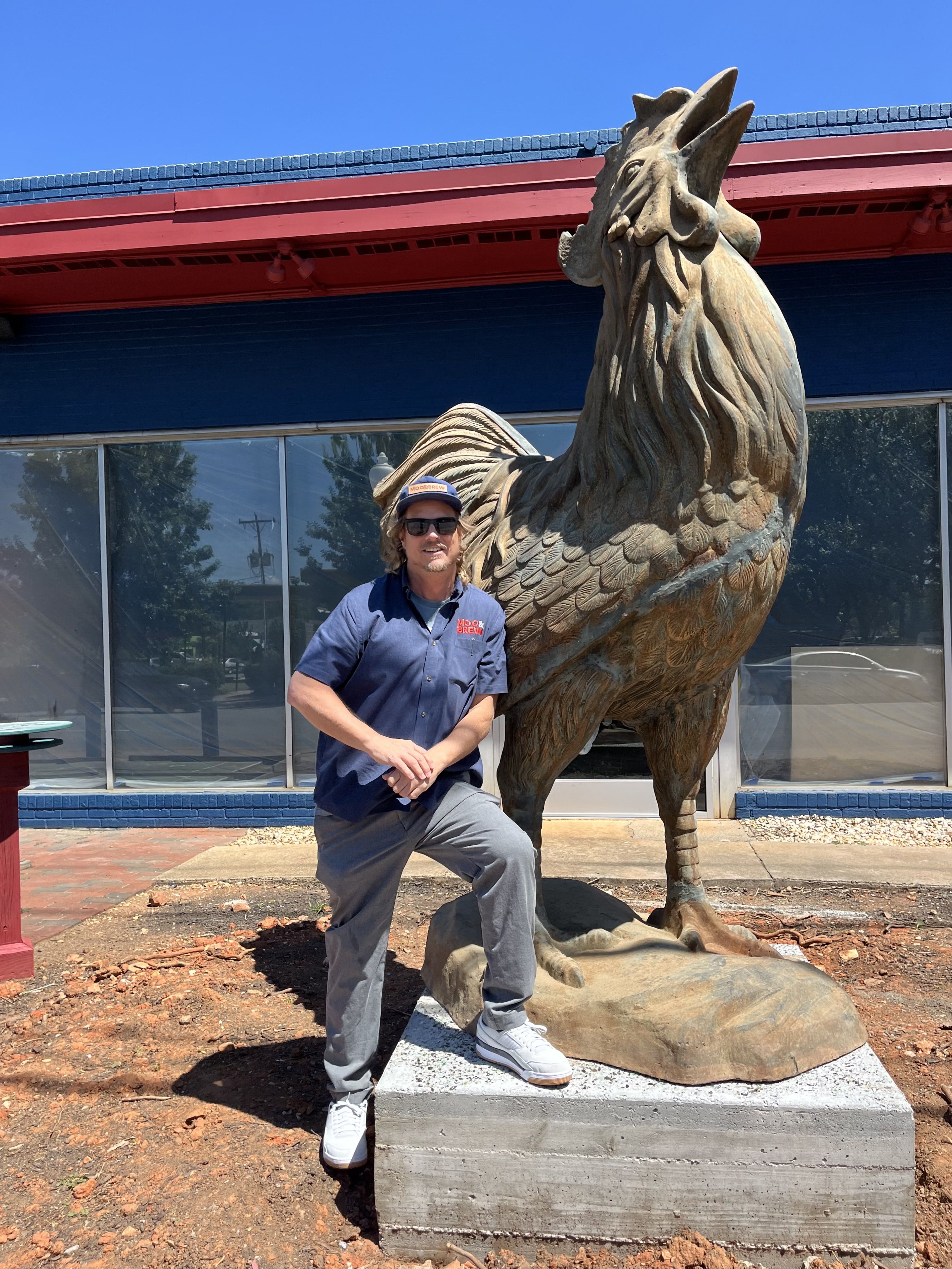 Current stands next to rooster