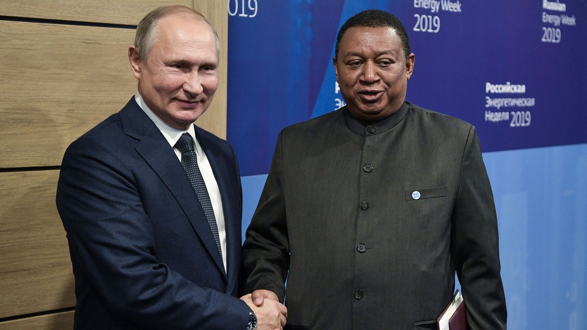 OPEC Secretary General Mohammed Barkindo (R) shakes hands with Russian President Vladimir Putin (L) during their meeting on the sidelines of the 2019 Russian Energy Week forum in Moscow, on October 2,