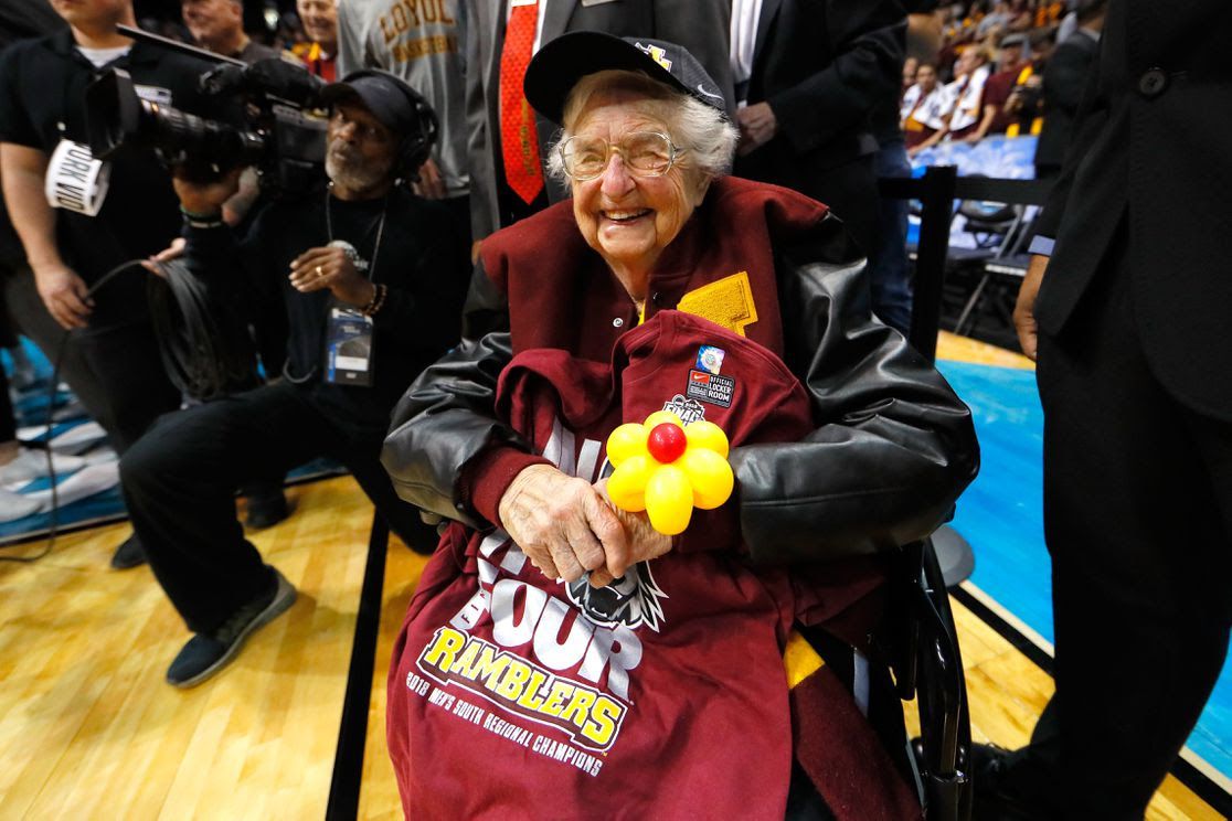 An old woman covered in final four gear.
