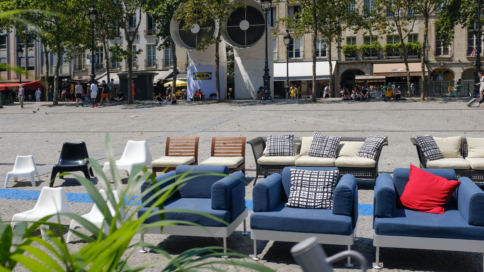 Blue and white couches on a street