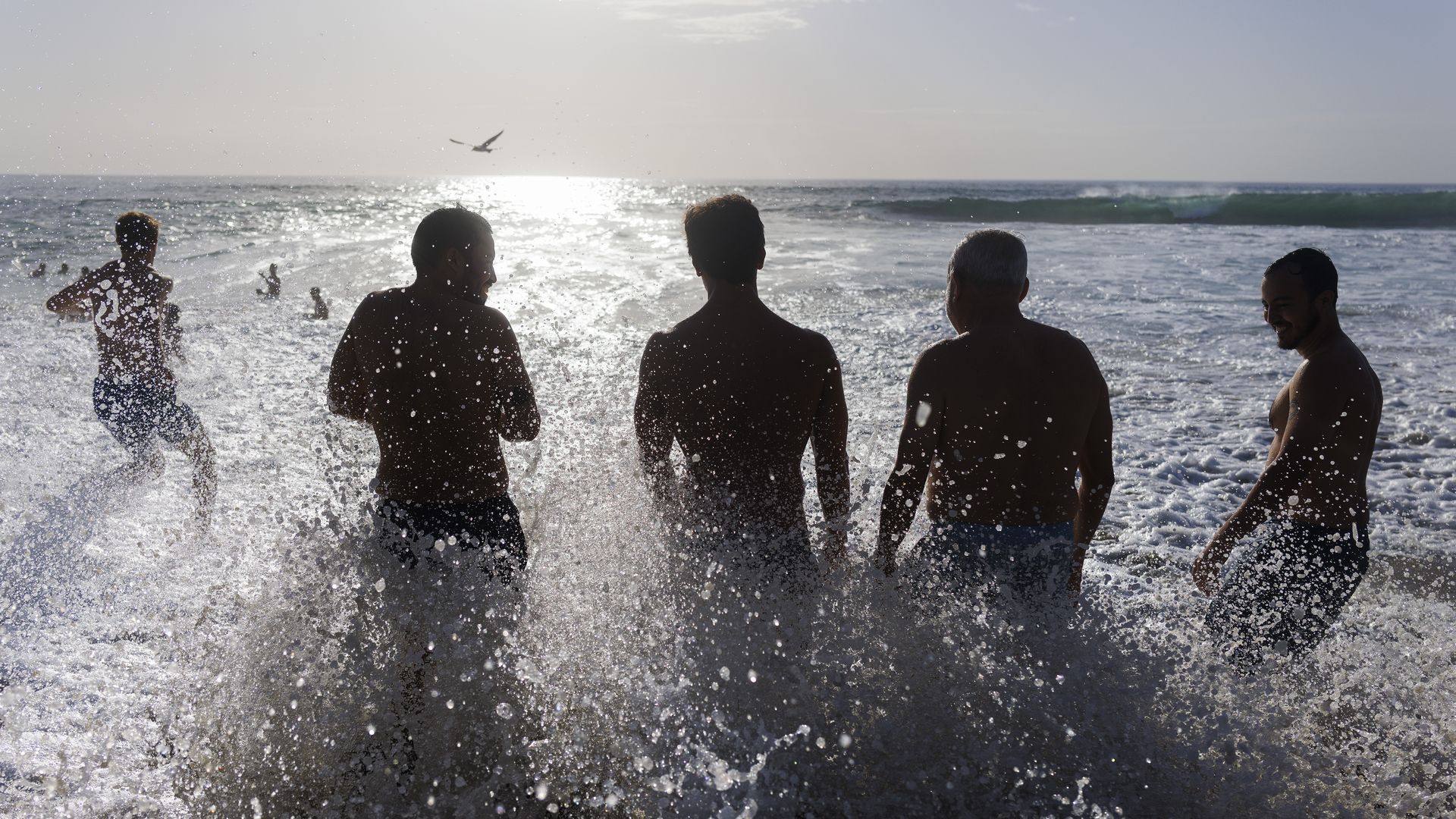 SAN DIEGO, CALIFORNIA - OCTOBER 17: A wave crashes through people gathered along the shore at Windansea beach in La Jolla after the National Weather Service issued a heat advisory for the coastal region on October 17, 2026 in San Diego, CA. (Photo by Kevin Carter/Getty Images)