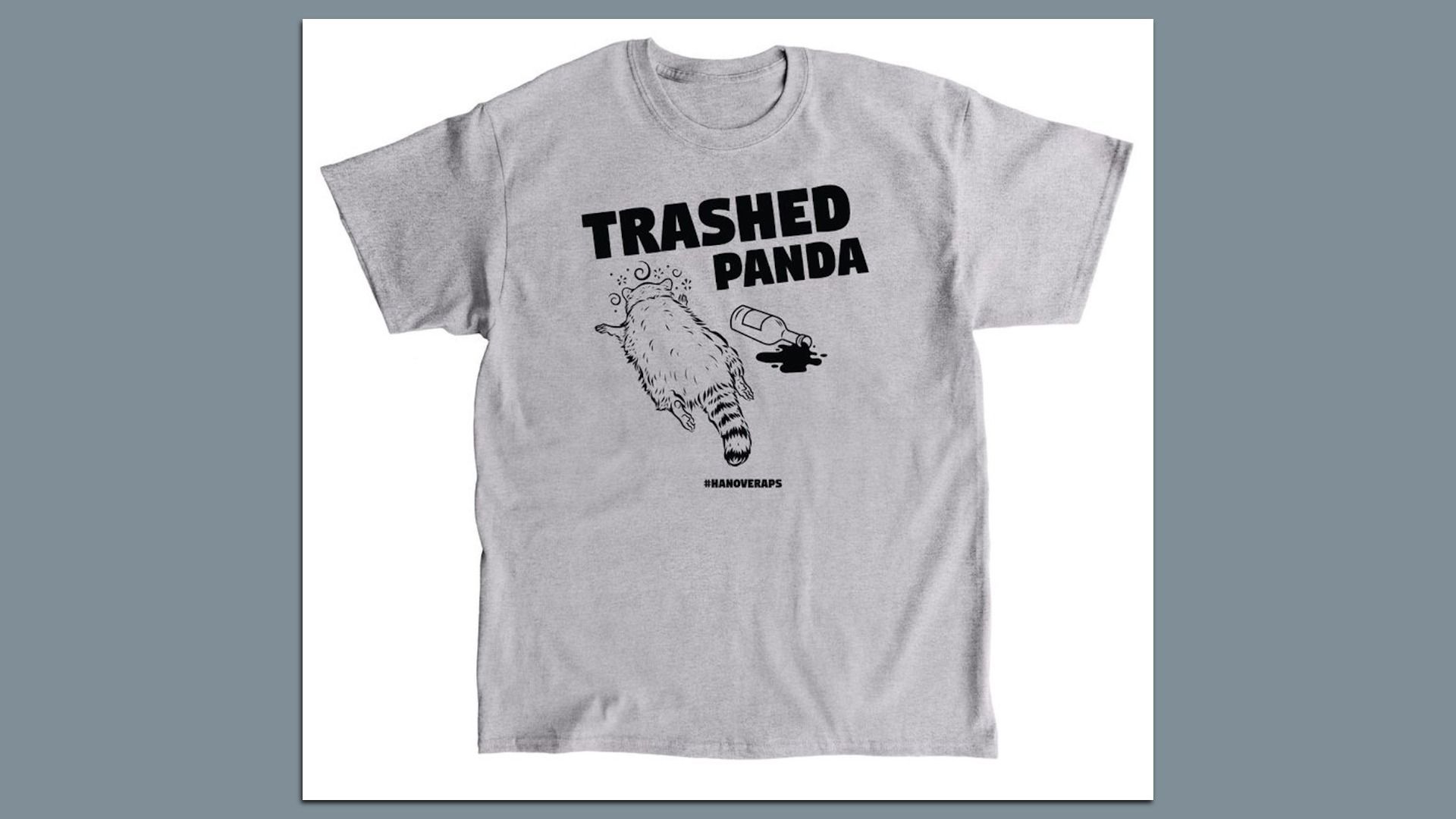 Light gray T-shirt with black text "TRASHED PANDA" above a drawing of a drunken raccoon lying on its stomach next to a spilled bottle, with hashtag #HANOVERAPS below.