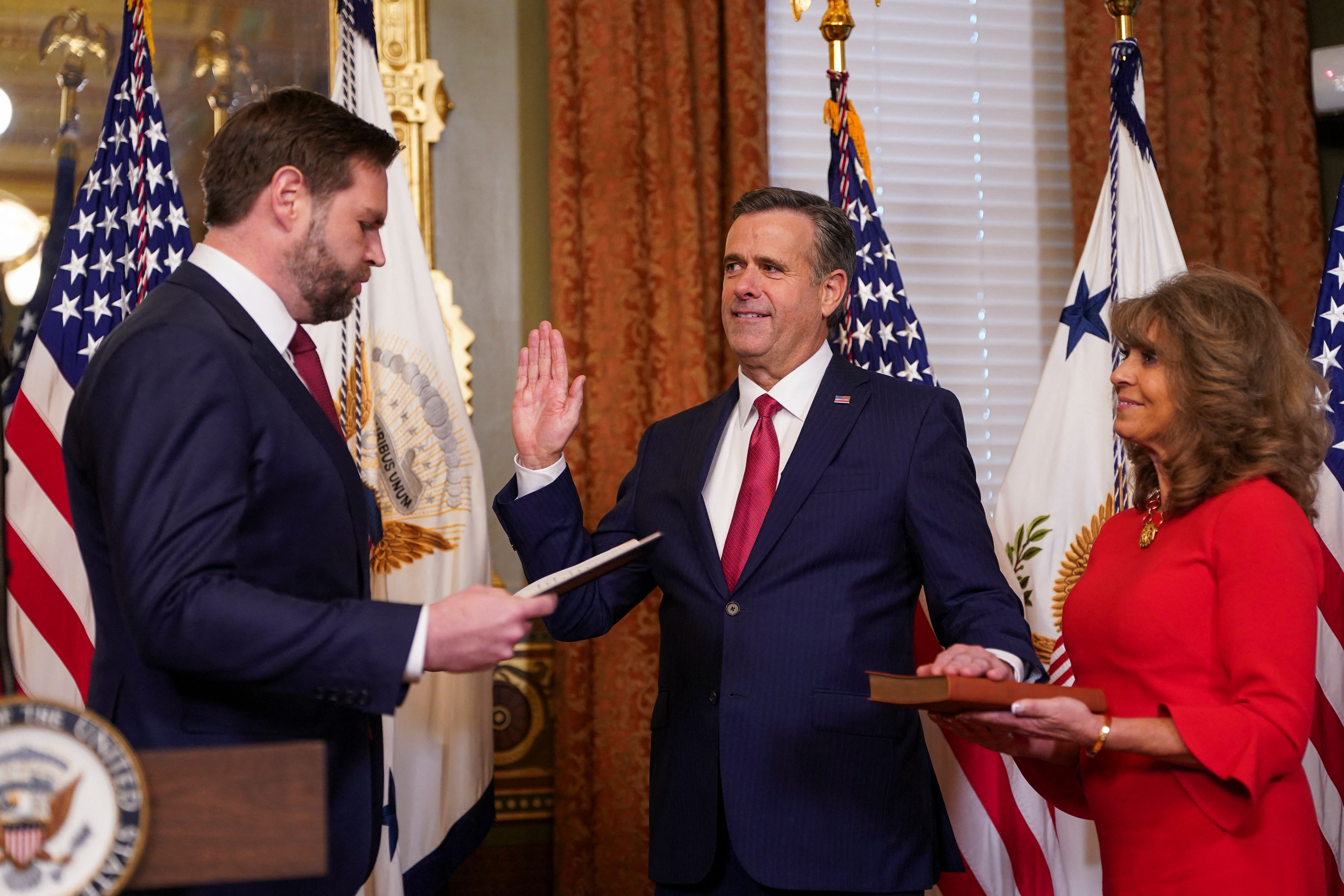 Vice President JD Vance swears in CIA Director John Ratcliffe yesterday in the Vice President's Ceremonial Office in the Eisenhower Executive Office Building, next to the White House. His wife, Michele, holds the Bible. Photo: Nathan Howard/Reuters