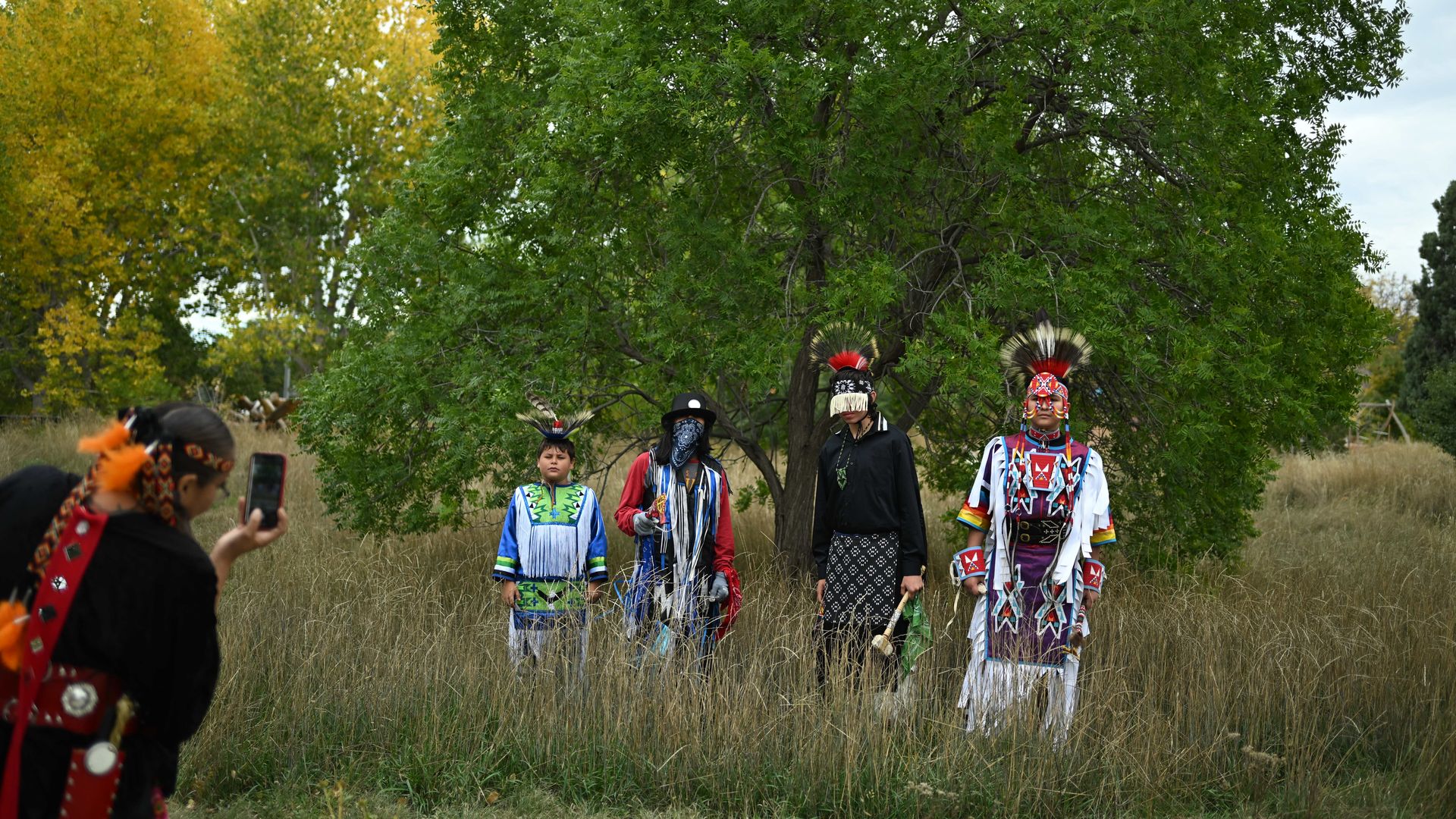 Dancers pose for a photo at a 2025 Indigenous Peoples Day celebration in Denver. Photo: Mark Makela/Getty Images