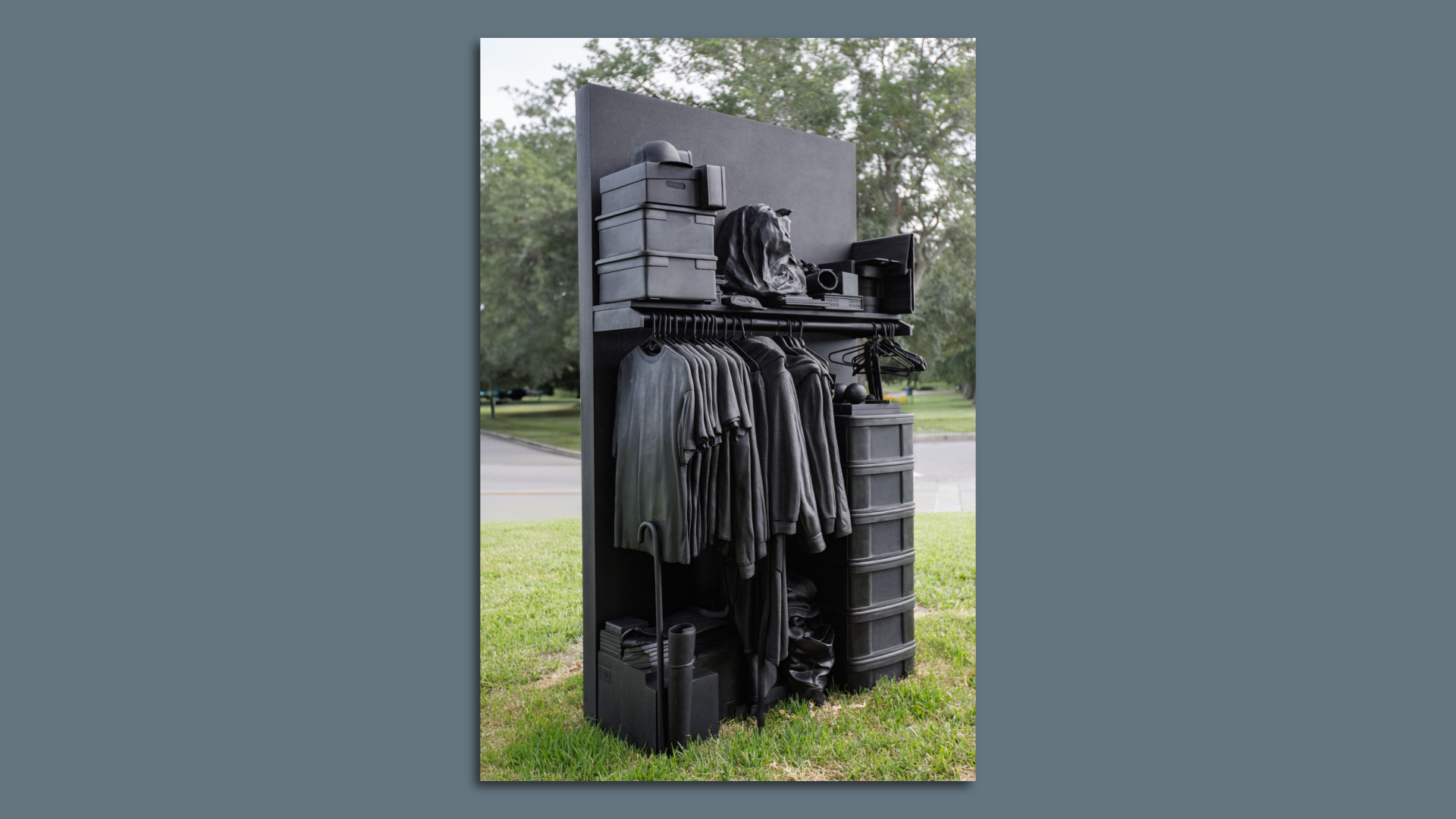 Photo shows a black metal sculpture of a closet.