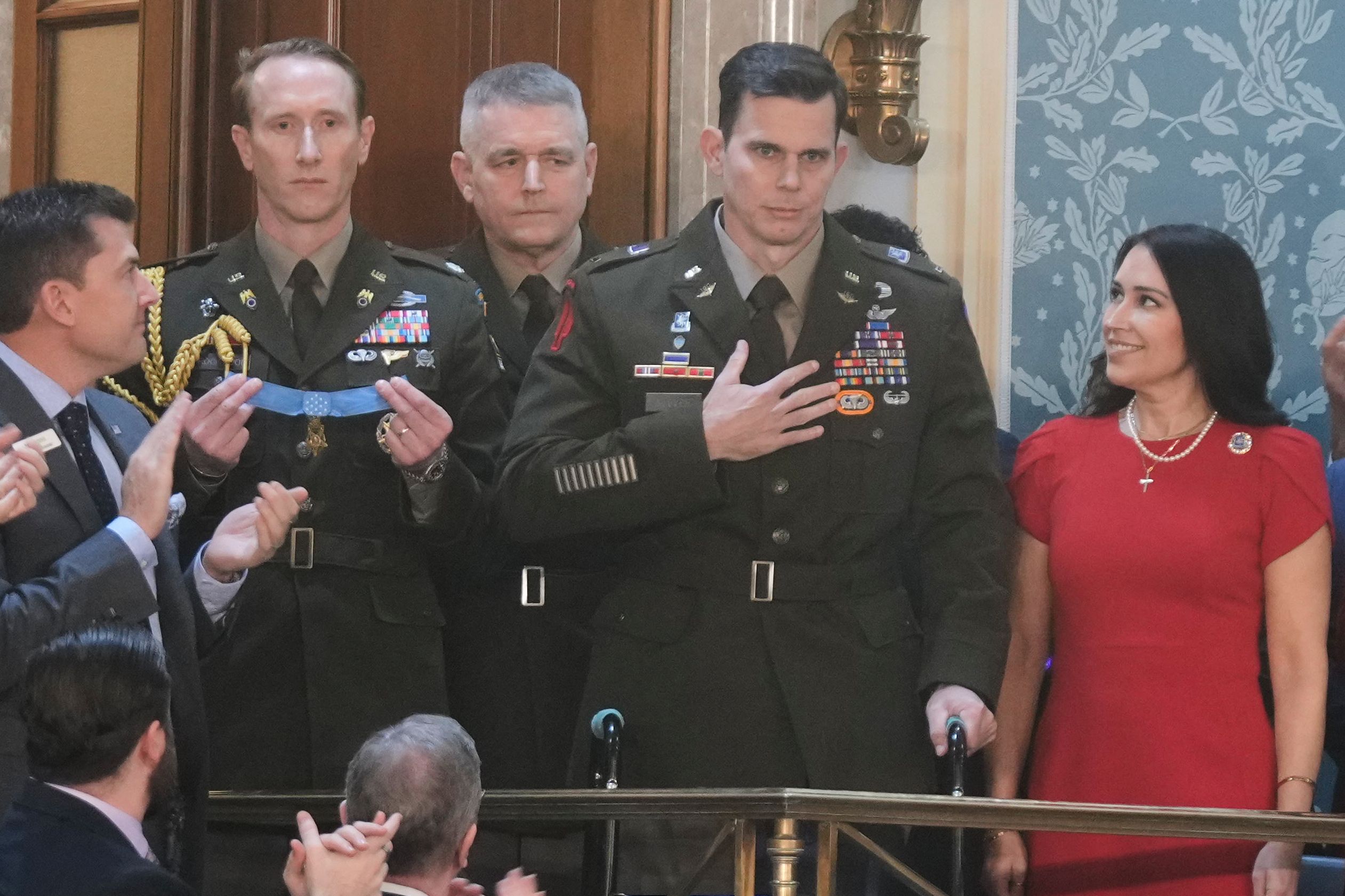 Army Chief Warrant Officer Eric Slover receives the Congressional Medal of Honor last night. Photo: Mark Schiefelbein/AP Heroes highlighted by Trump included Army Chief Warrant Officer 5 Eric Slover, a helicopter pilot wounded in last month's risky Maduro raid in Venezuela. Slover, who used a walker