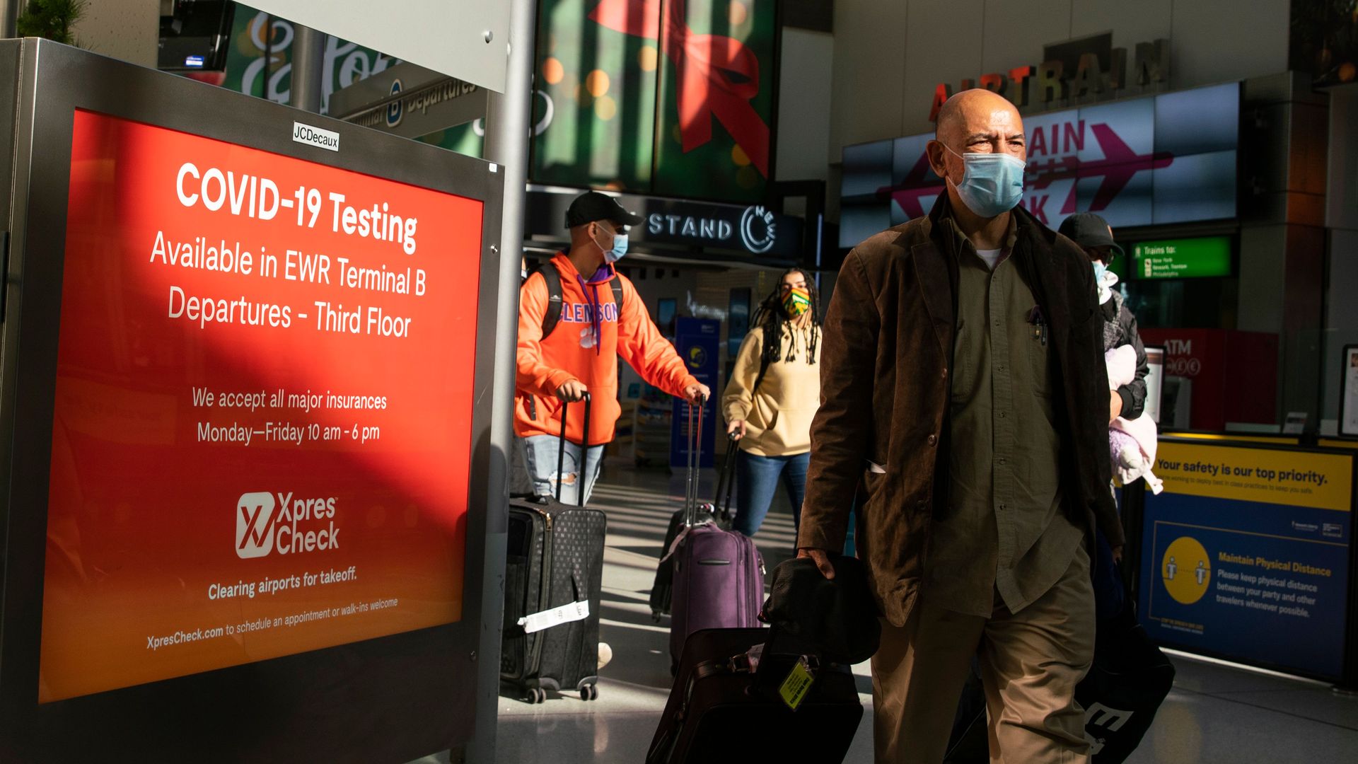 Travelers walk through Newark International Airport on November 21, 2020 in Newark, New Jersey. 
