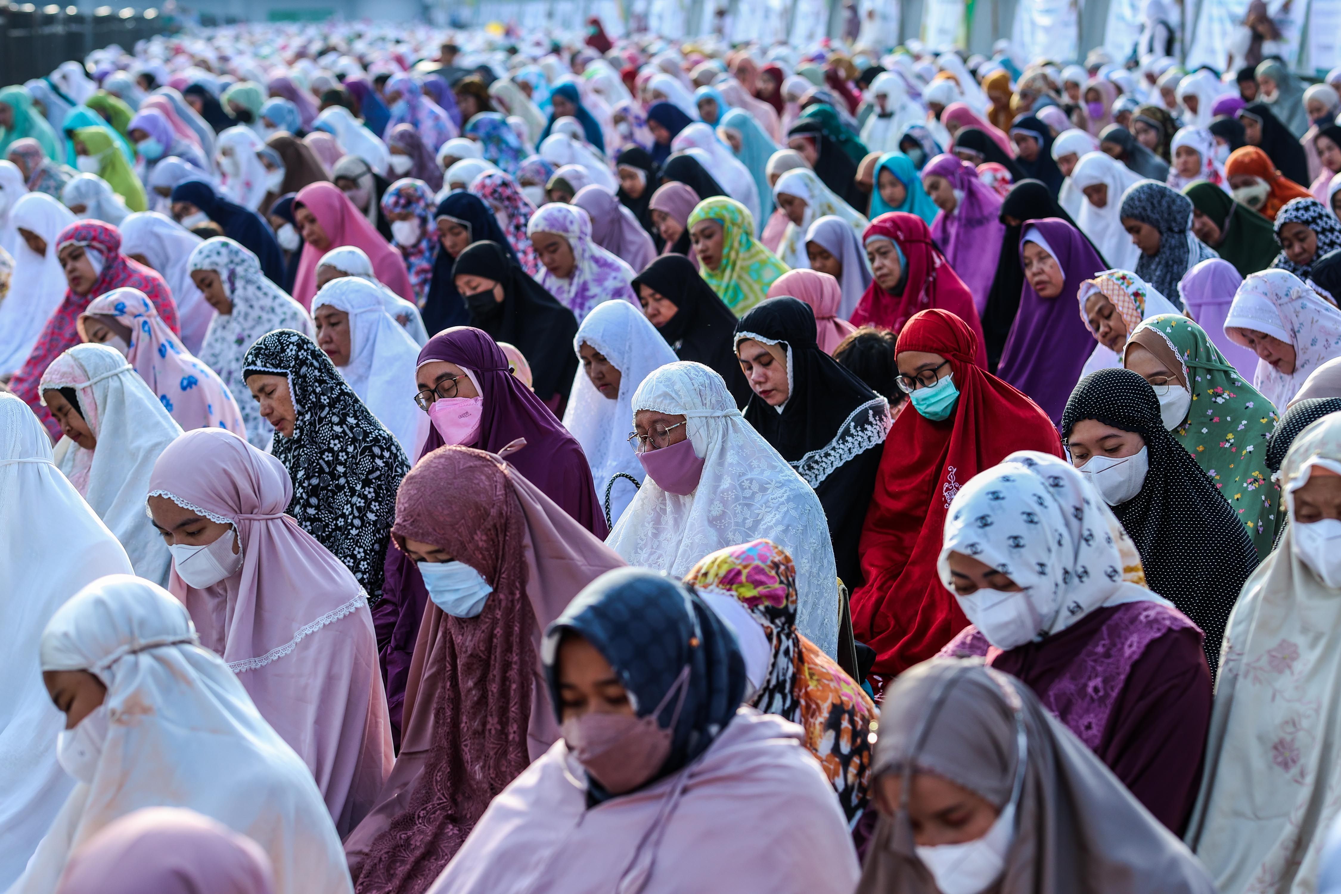Muslim worshippers attend prayers during Eid al-Fitr, marking the end of the holy fasting month of Ramadan at the Jakarta International Stadium in Jakarta, Indonesia, May 2, 2022