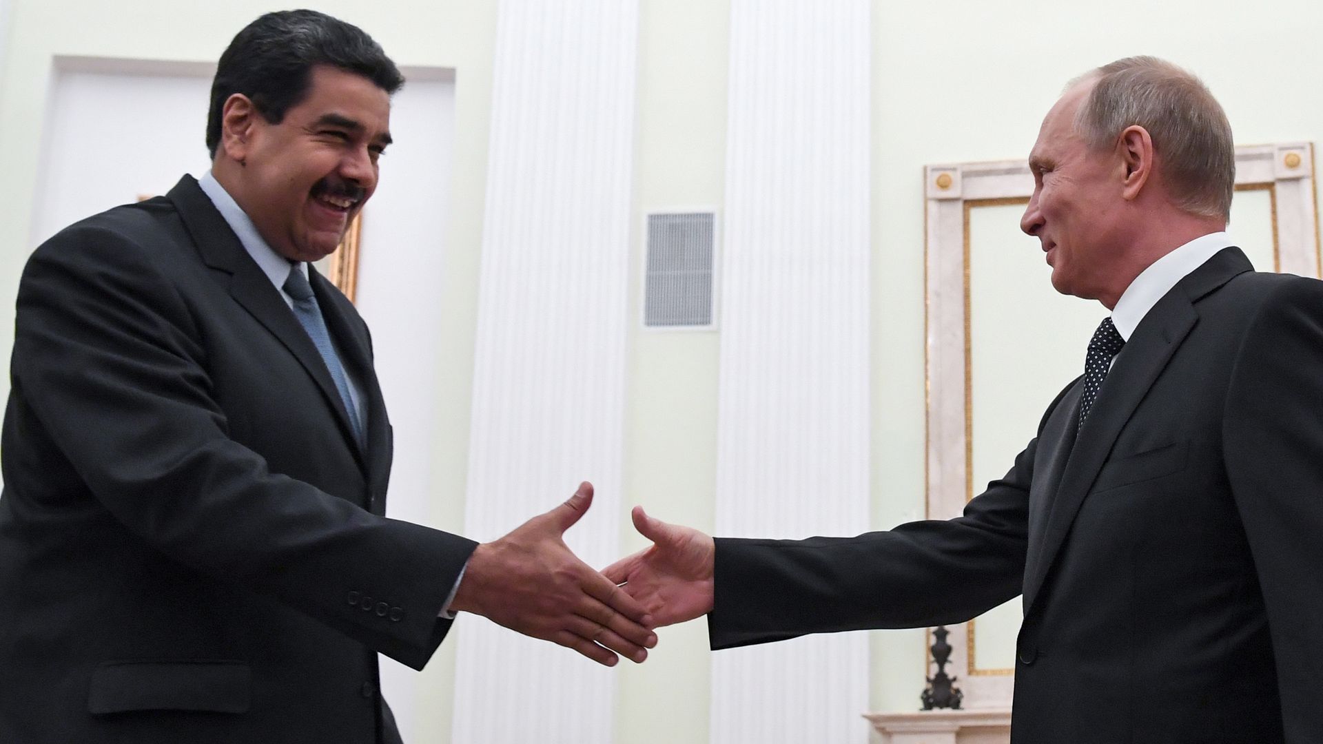Russian President Vladimir Putin (R) shakes hands with his Venezuelan counterpart Nicolas Maduro during a meeting at the Kremlin in Moscow on October 4, 2017. 