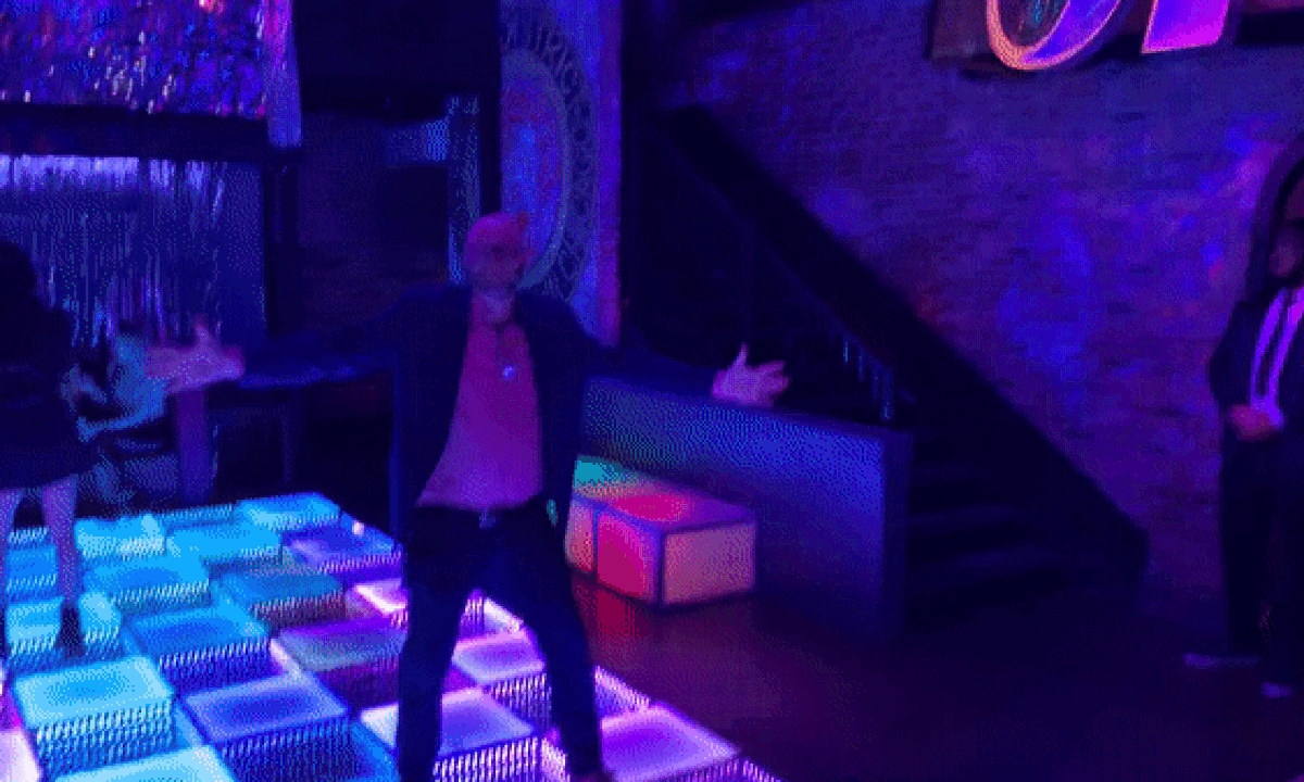 GIF of a man dancing on dance floor at a club. 