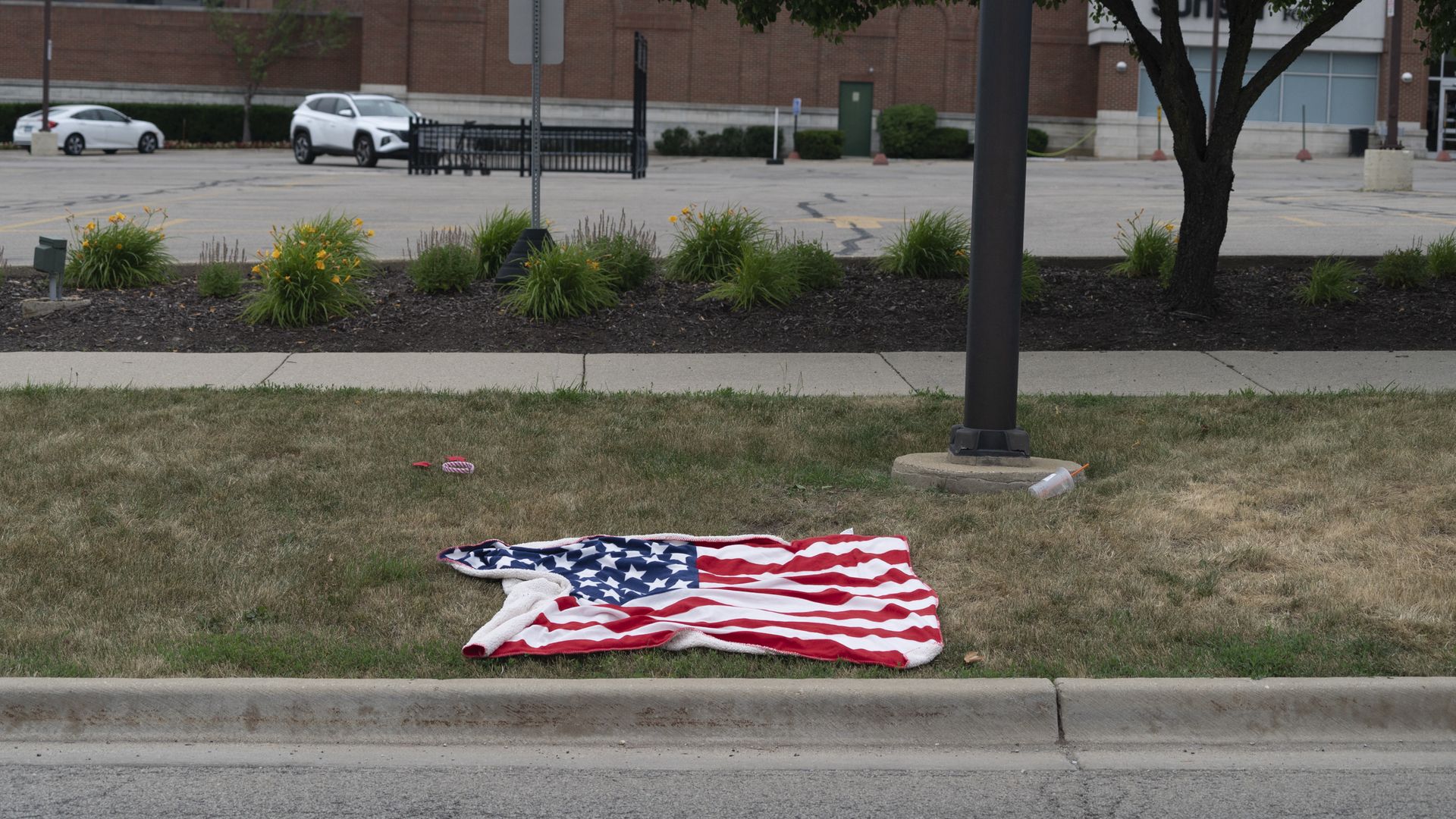 Photo of an American flag towel laying on the ground. 