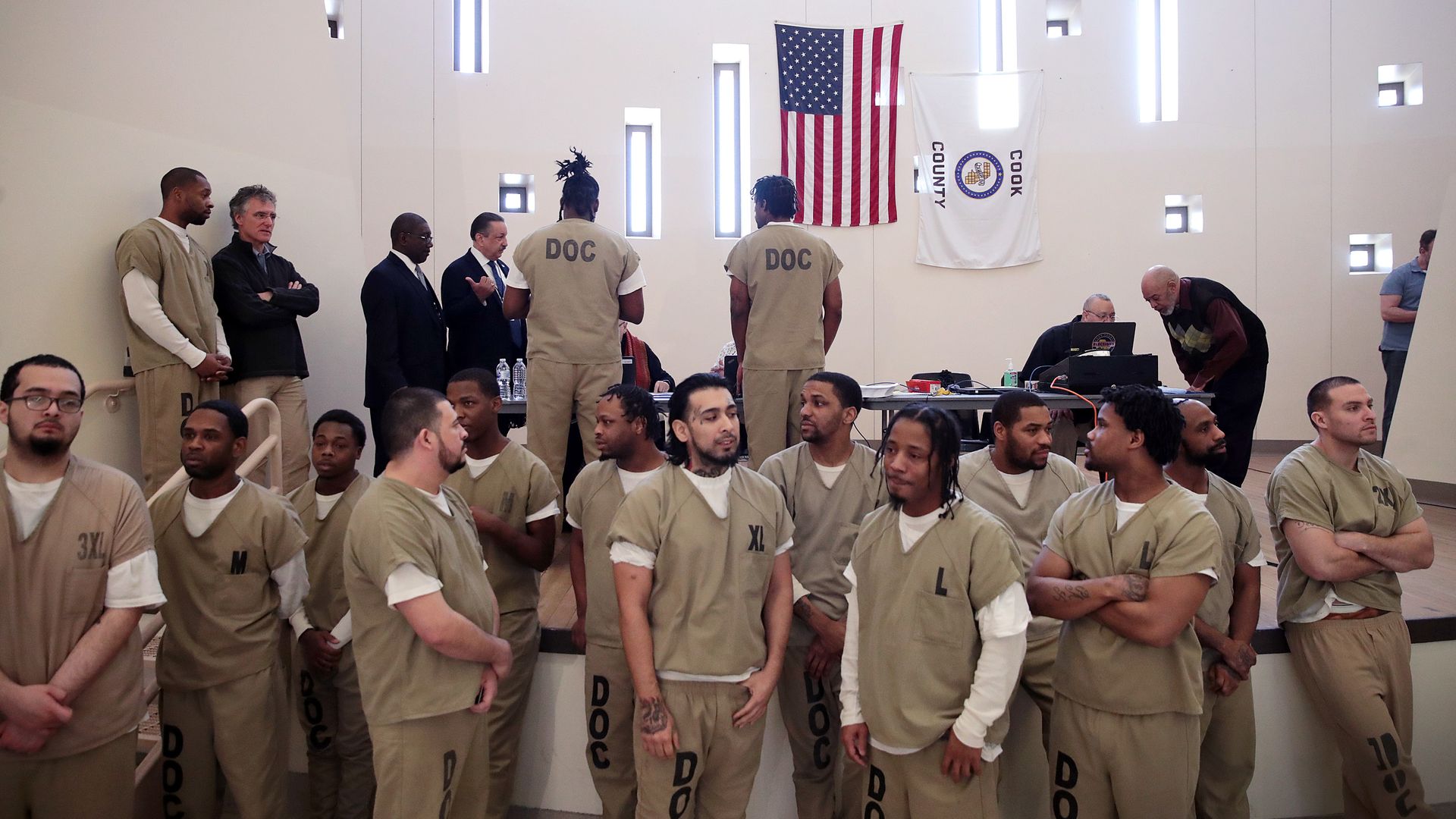 In this image, inmates vote under an American flag