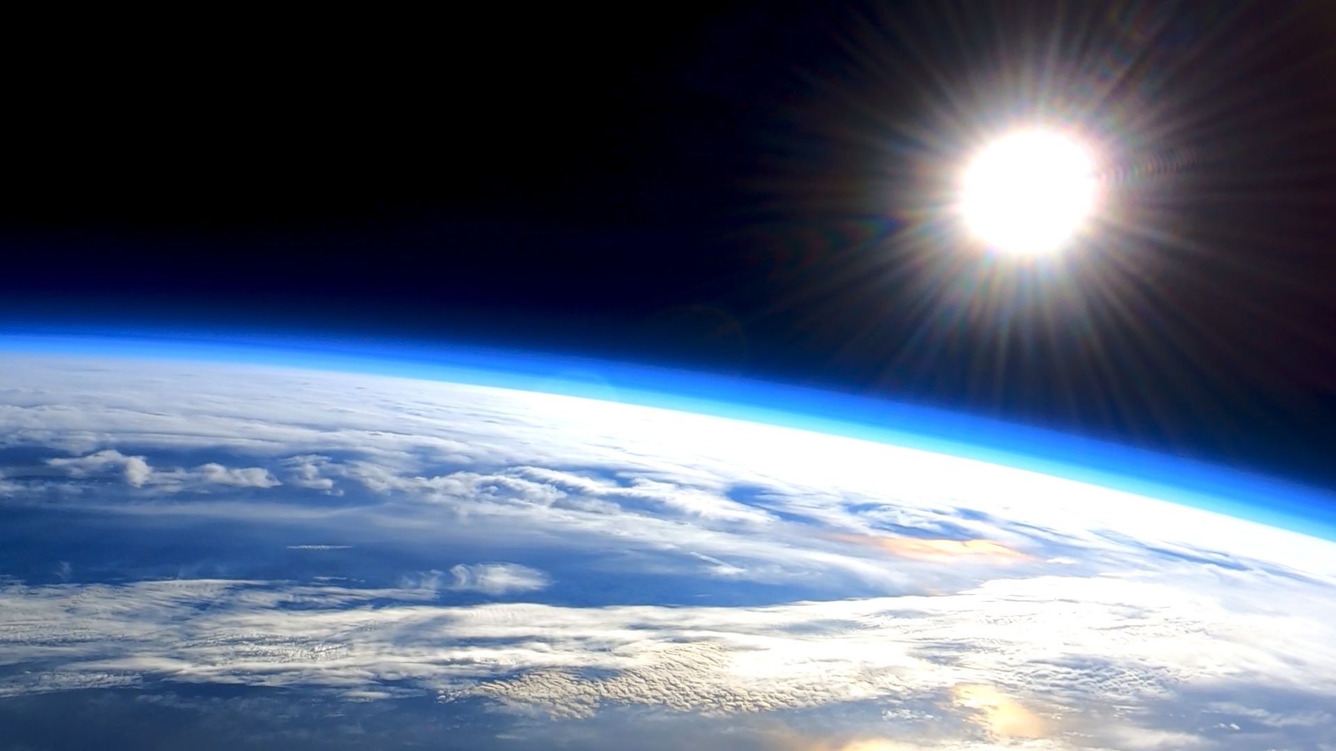 Photo of the sun over the earth's atmosphere from the viewpoint of space