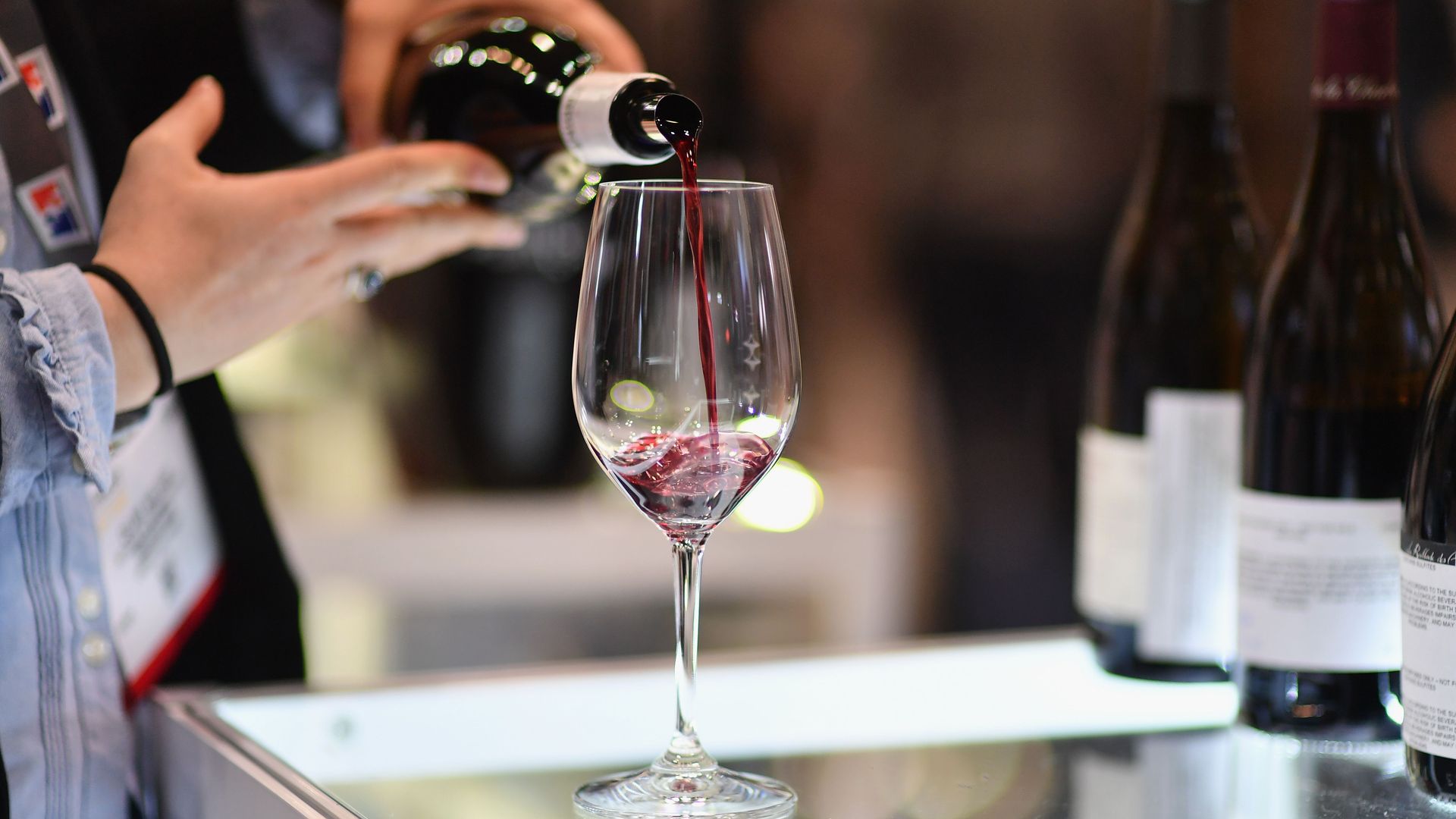 An exhibitor pours a glass of red wine during the Vinexpo at Javits Center on March 2, 2020 in New York City. 