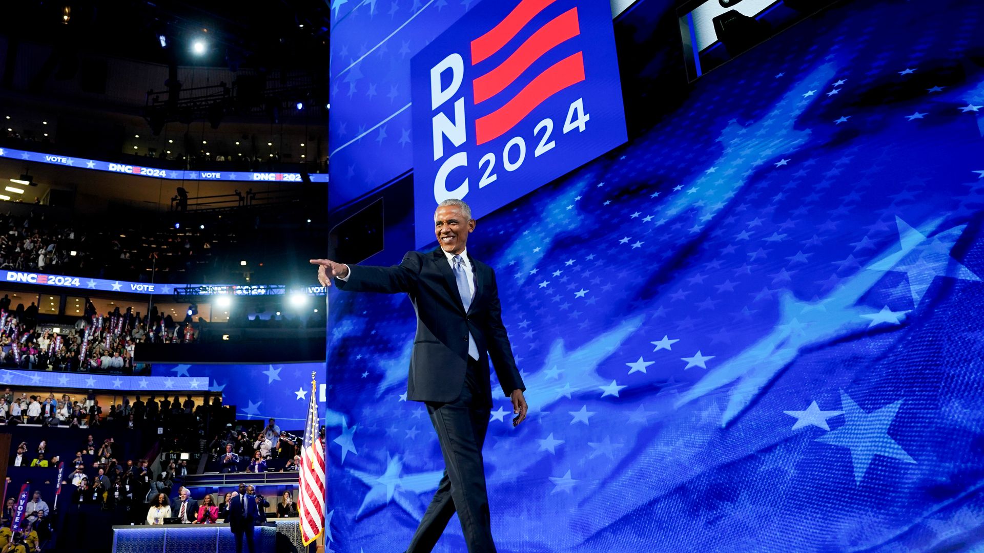 Former President Obama gestures to the crowd onstage at the Democratic National Convention.