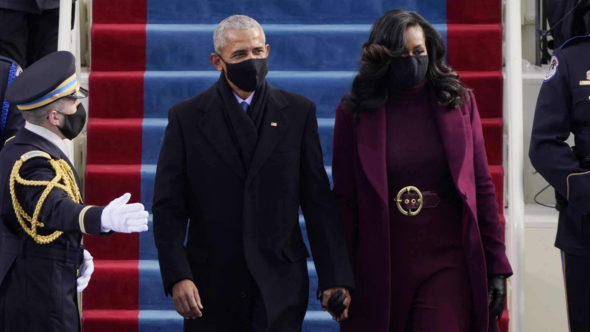 Picture of Michelle and Barack Obama wearing masks and holding hands during Joe Biden's inauguration