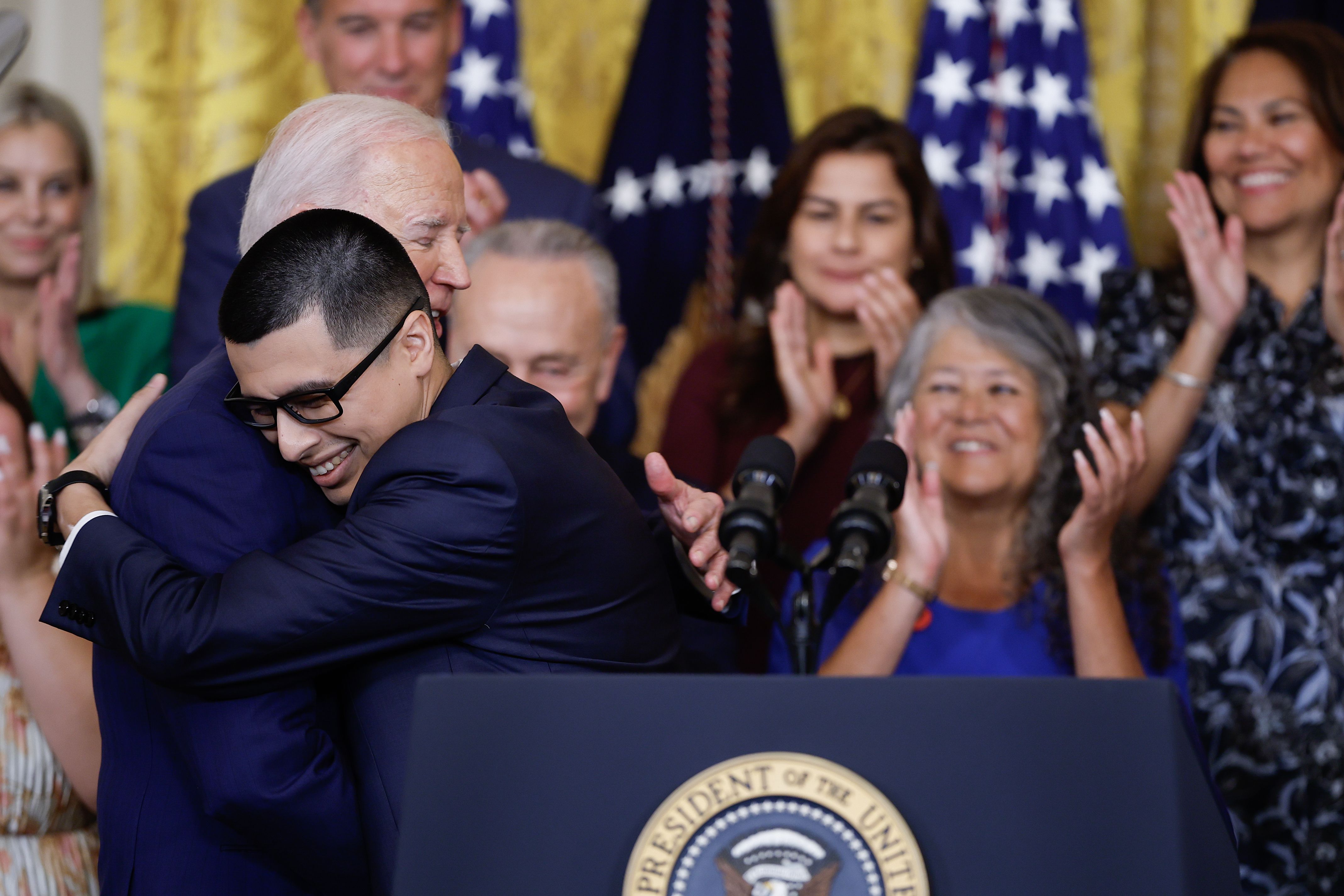President Biden is embraced by Javier Quiroz Castro, a DACA recipient, at an event marking the program's 12th anniversary at the White House yesterday.