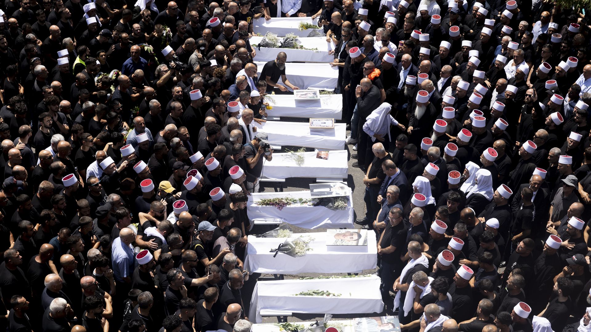 Mourners attend a funeral held for 10 of the victims of yesterday's rocket attack on July 28, 2024 in Majdal Shams, Golan Heights. 