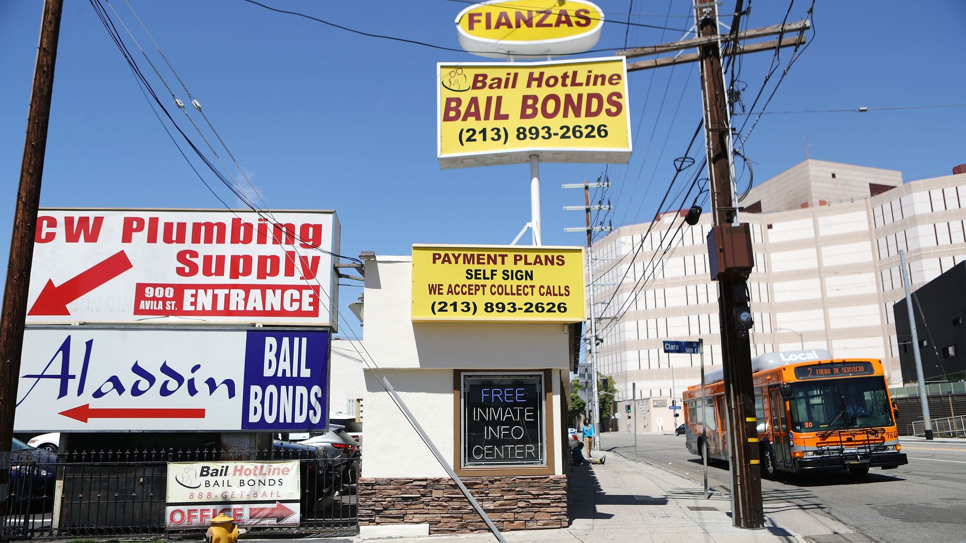 A small building with various signs and billboards advertising bail bond payment plans and services