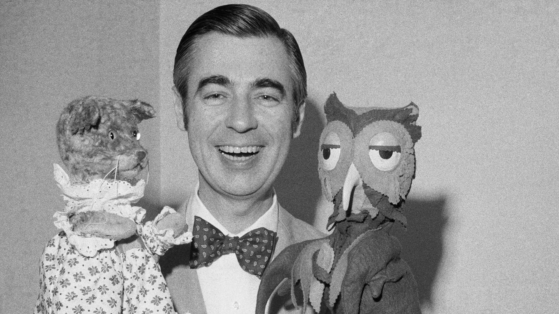 Fred Rogers of Mister Rogers' Neighborhood holds Henrietta Pussycat (left) and "X" the Owl during an interview. Rogers is an ordained Presbyterian minister and his ministry works to reach out to children and their families through mass media.