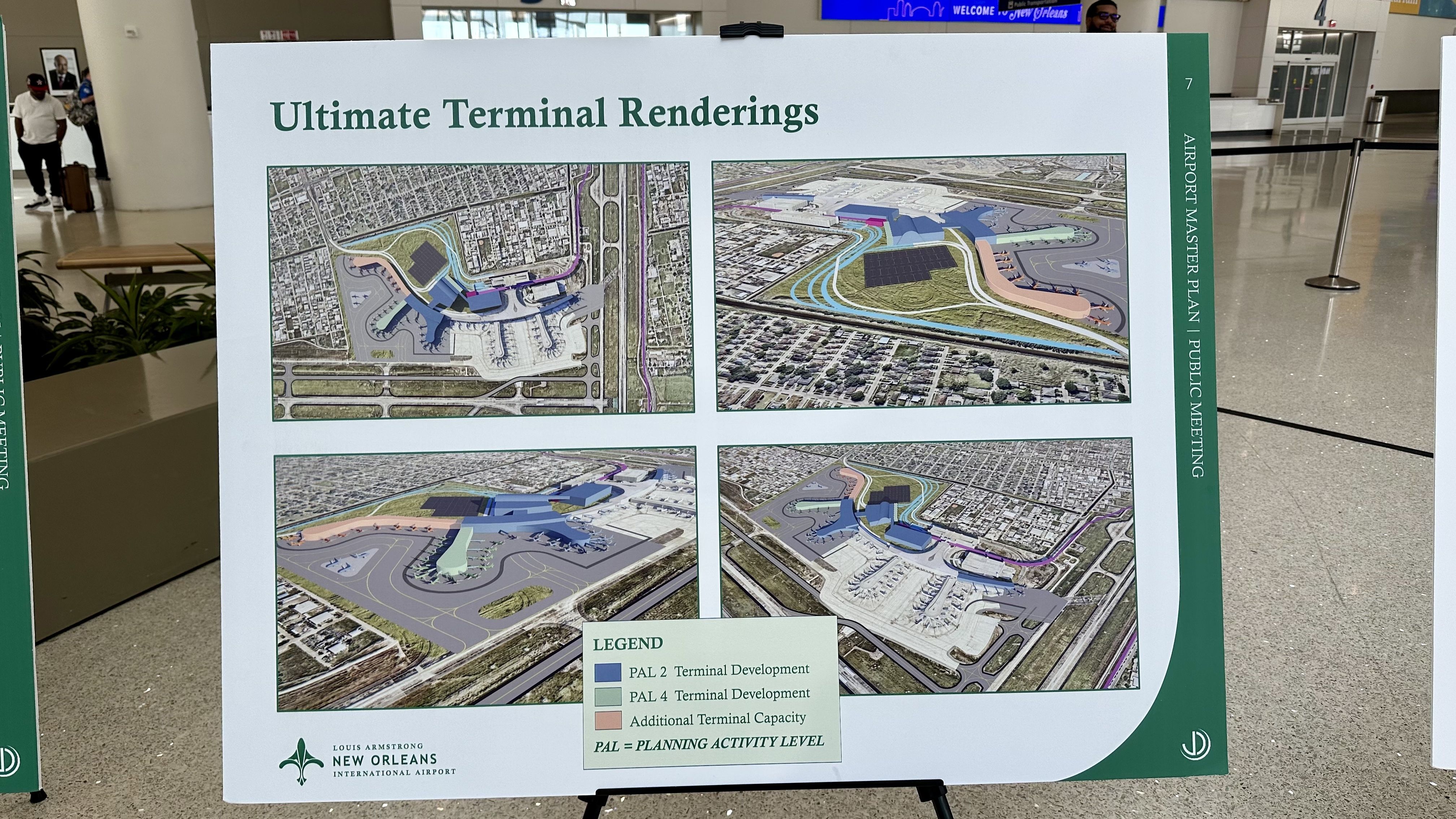 Display board titled "Ultimate Terminal Renderings" with four color renderings of airport terminals and a legend, located at Louis Armstrong New Orleans International Airport.