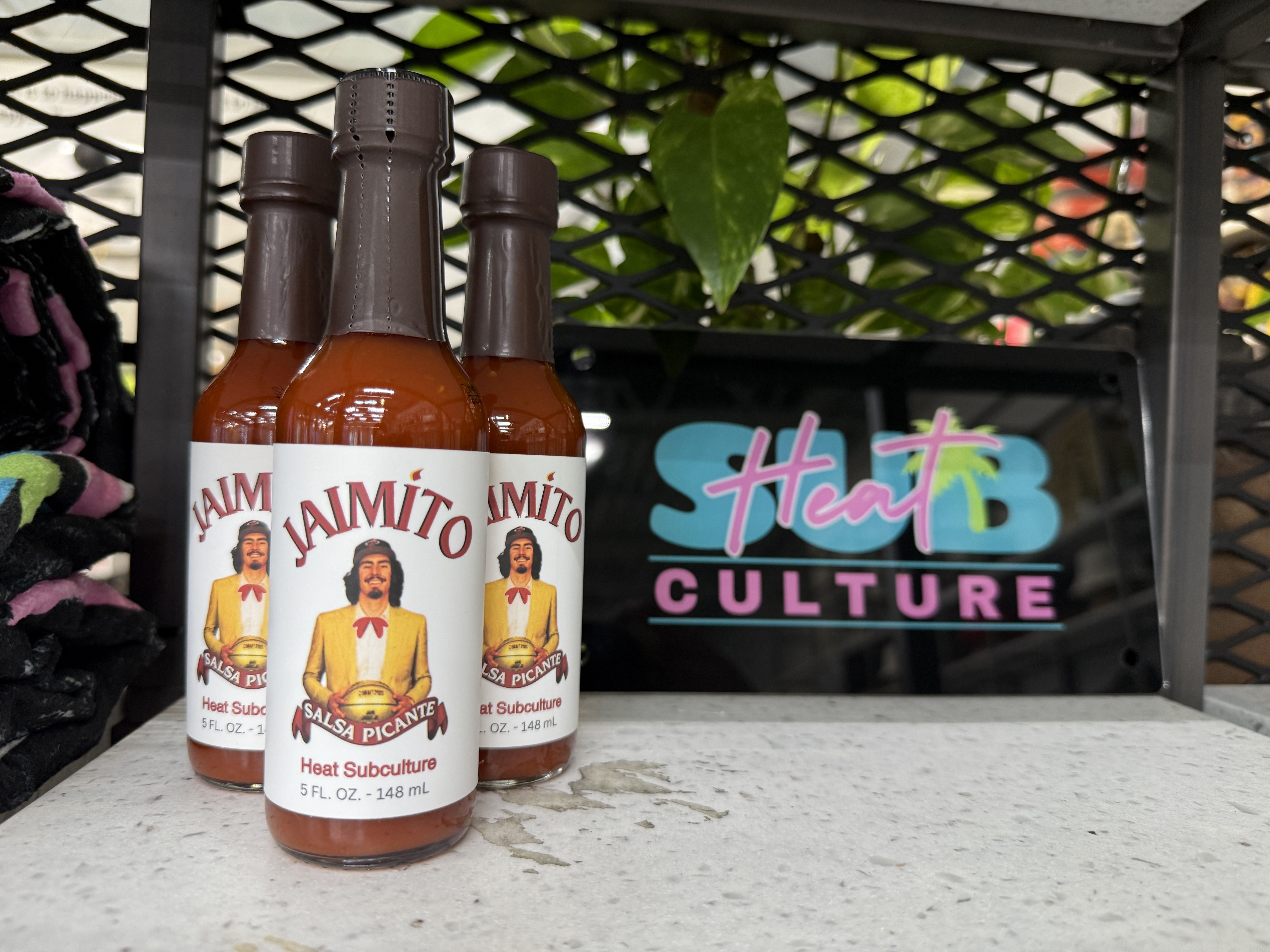 Three bottles of hot sauce. 