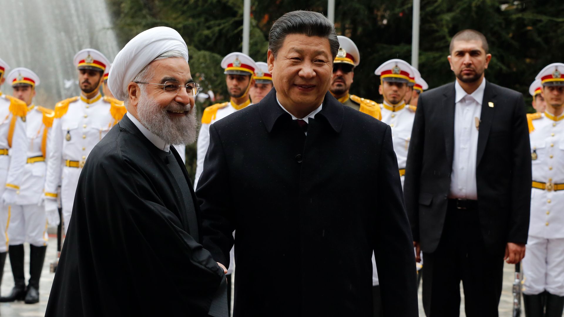 Iranian President Hassan Rouhani shakes hands with Chinese President Xi Jinping 