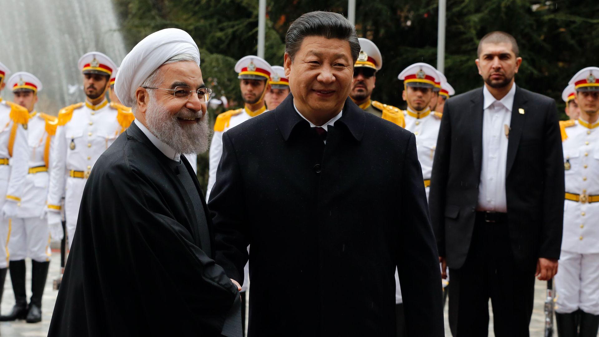 Iranian President Hassan Rouhani shakes hands with Chinese President Xi Jinping