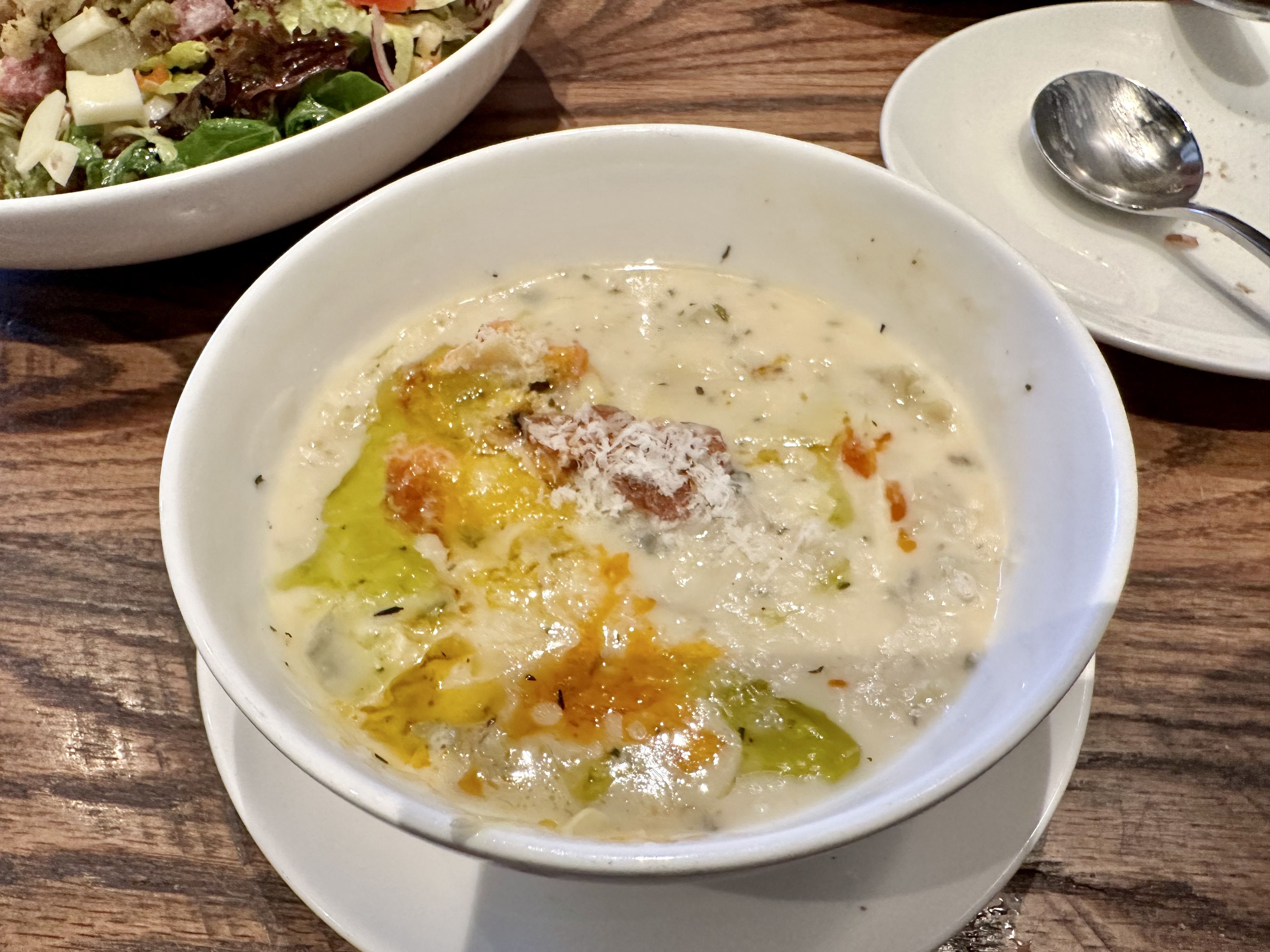 Photo shows a bowl of stuffed artichoke soup