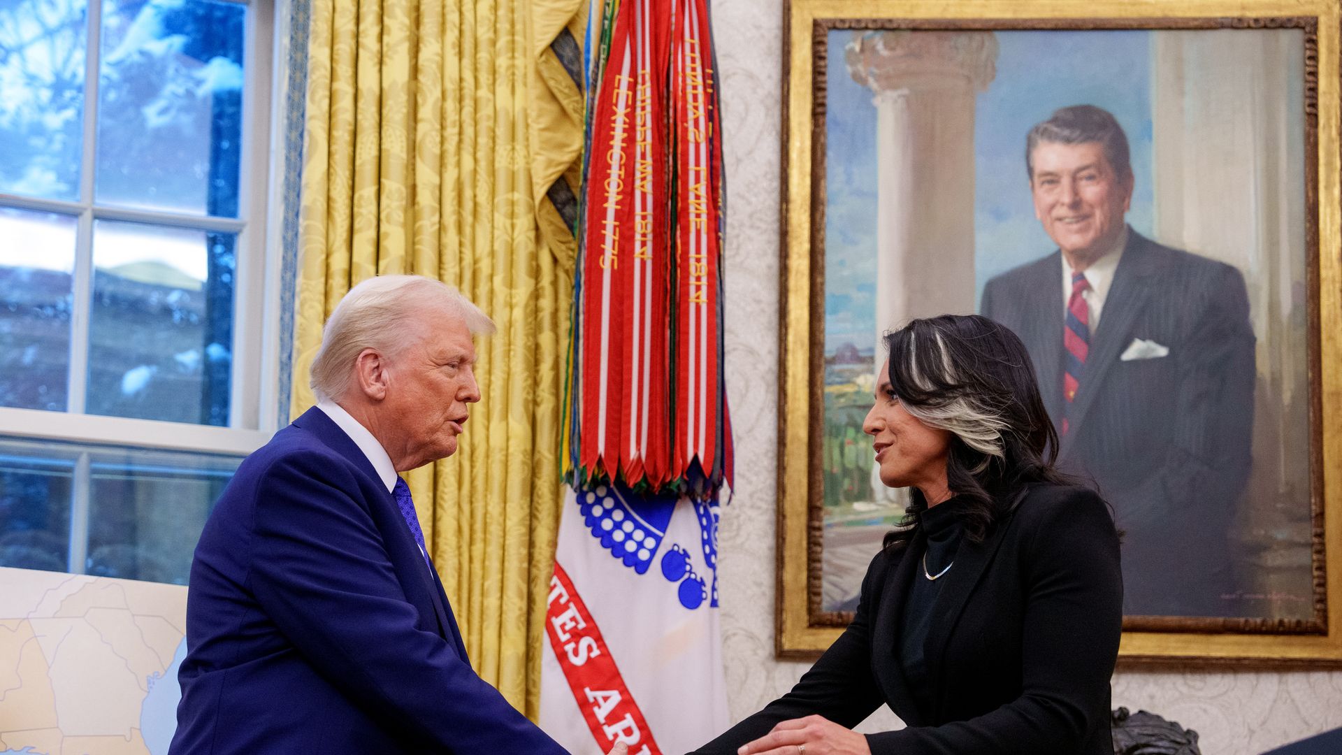 President Trump and Tulsi Gabbard shake hands in the Oval Office