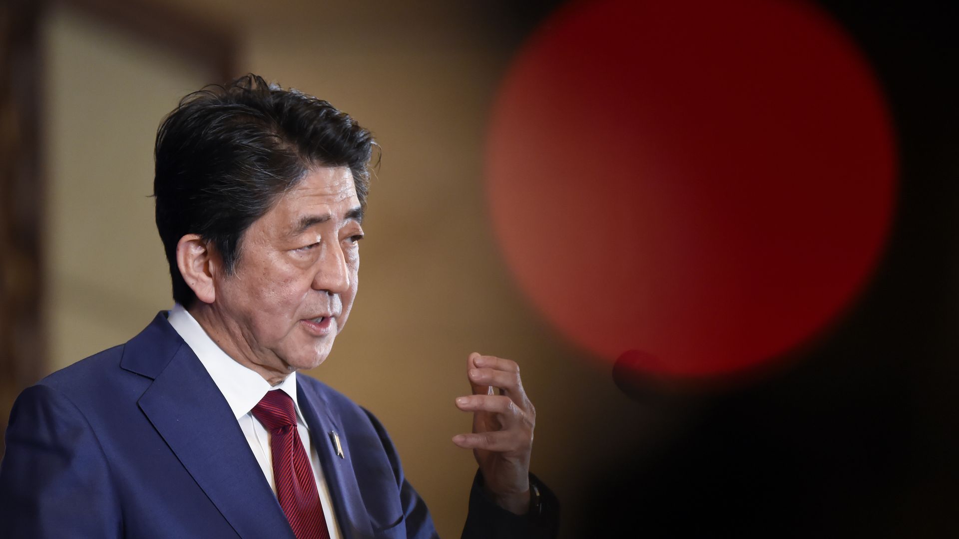 Former Japanese Prime Minister Shinzo Abe a question at a press conference after attending the 8th trilateral leaders' meeting between China, South Korea and Japan in Chengdu