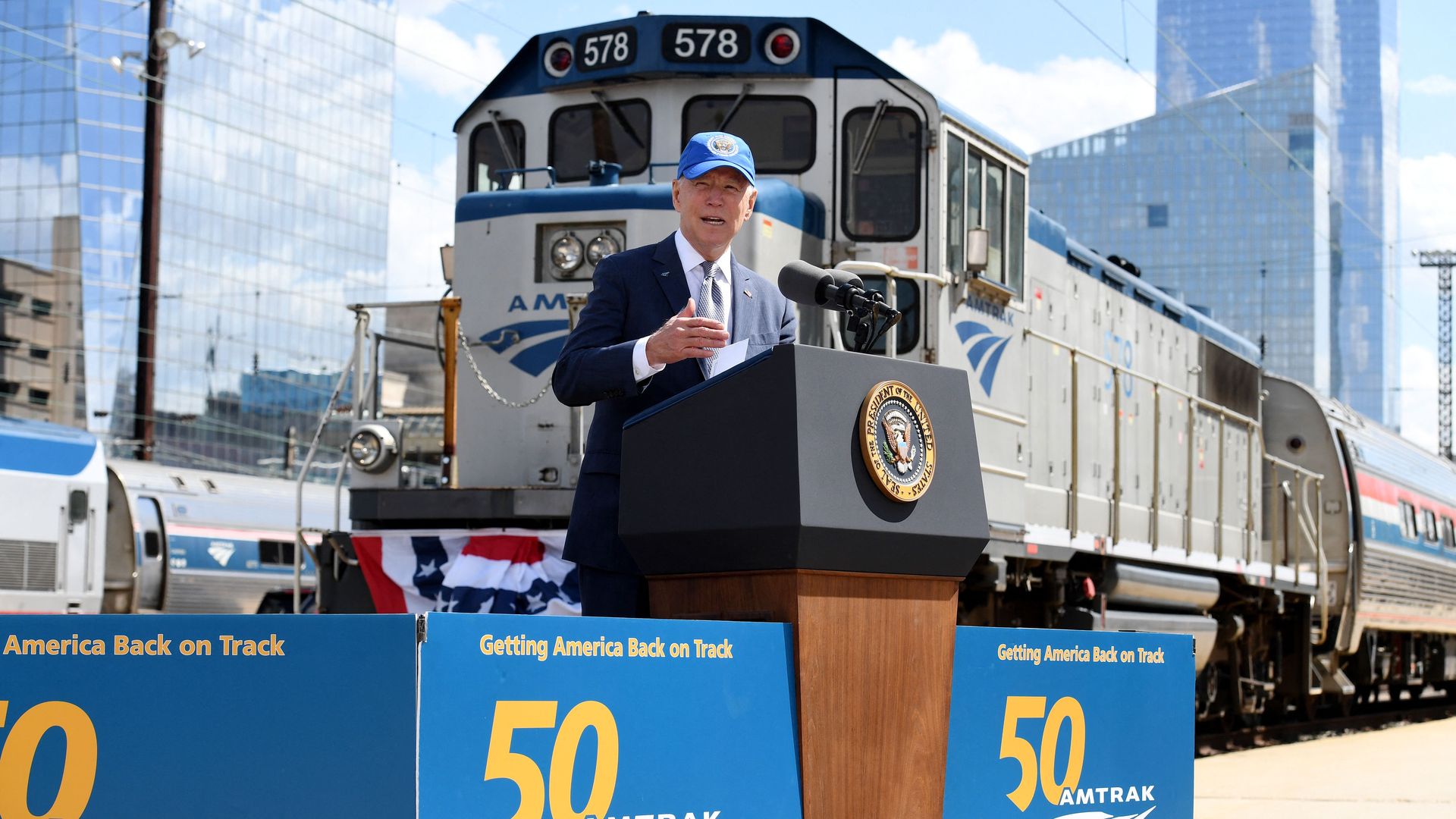 President Biden is seen speaking in front of an Amtrak train engine as he makes the pitch for his infrastructure proposal.