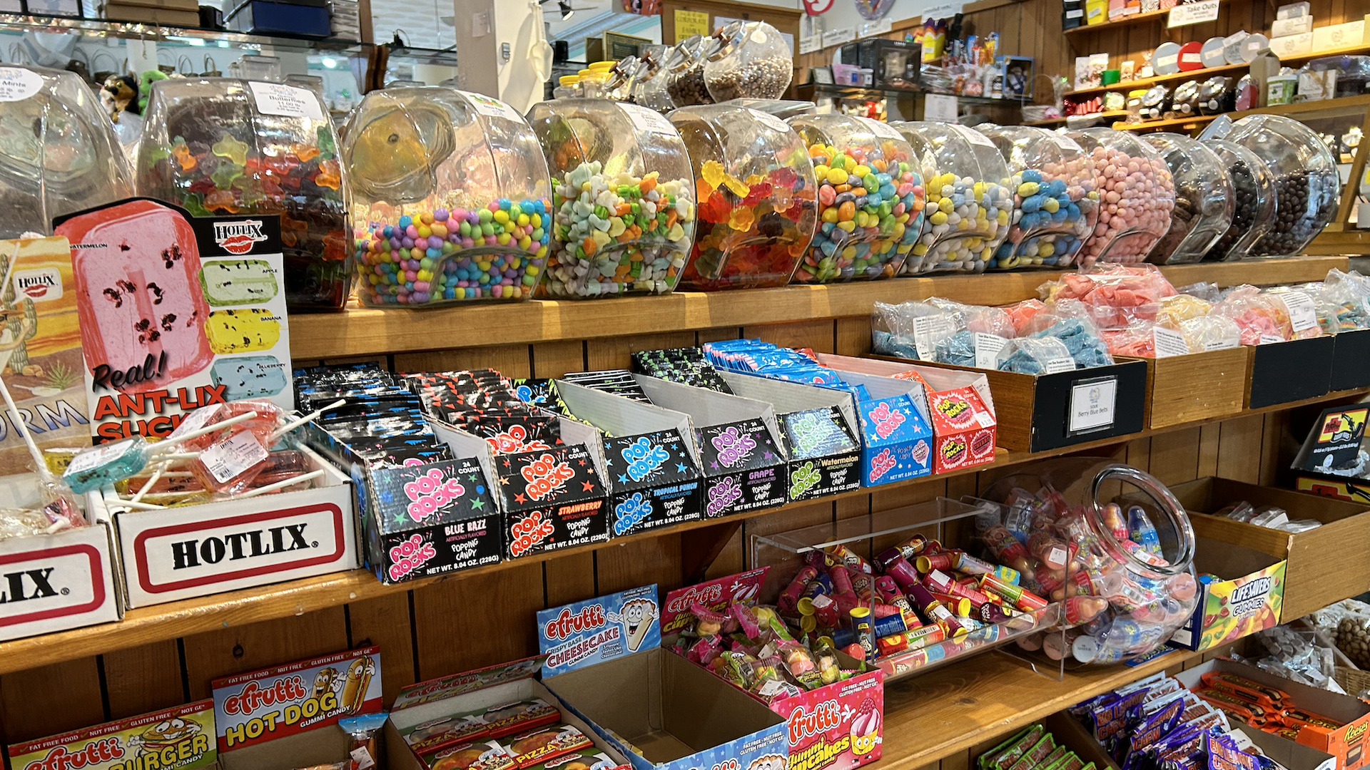 Shelves full of candy, including gumballs and Pop Rocks, at Windy City Sweets.