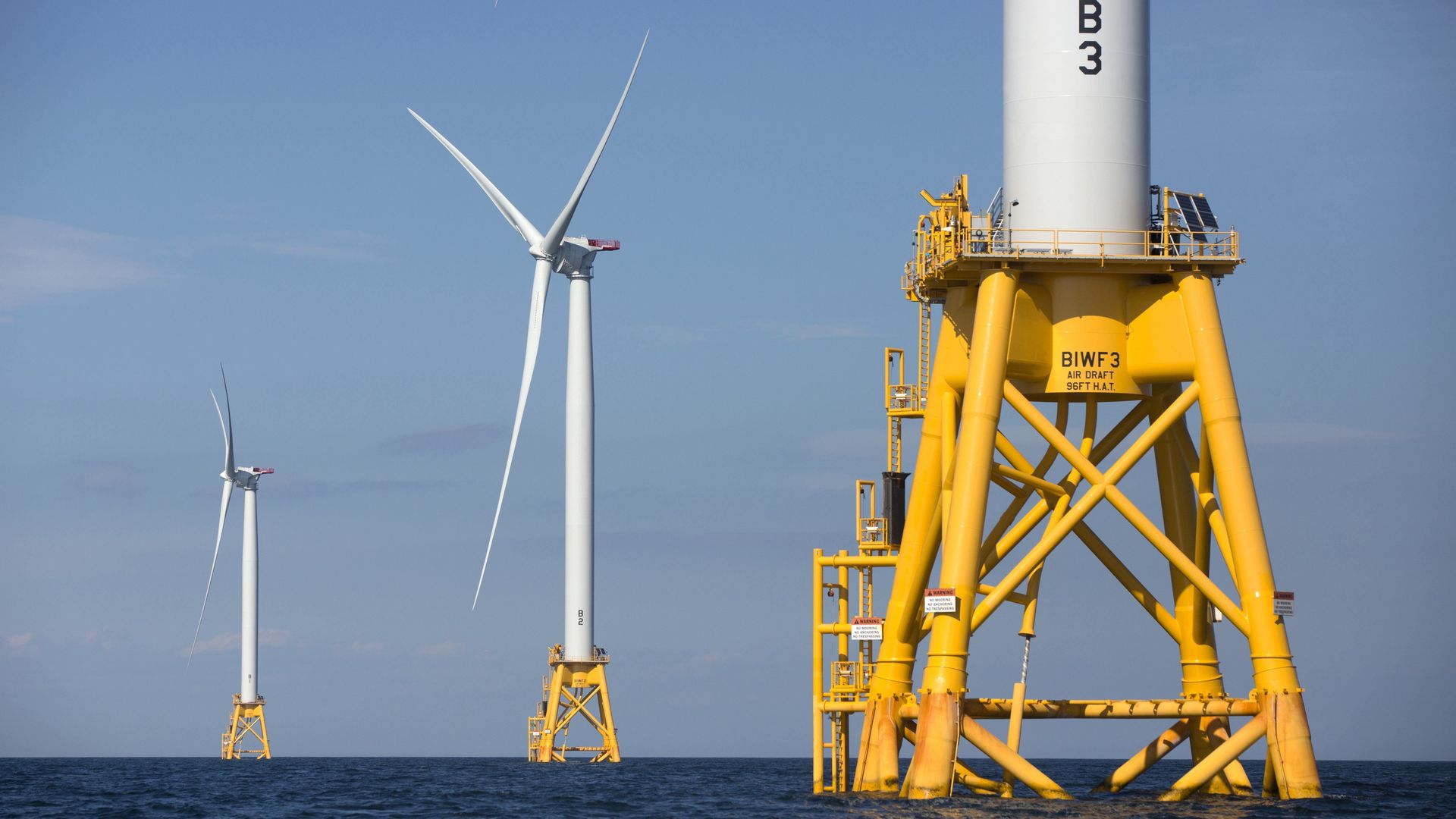 Three of Deepwater Wind's five turbines stand in the water off Block Island, R.I, the nation's first offshore wind farm.