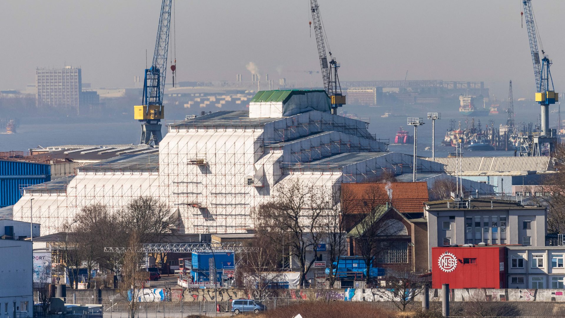 A giant scaffolding covered in tarpaulin covers the super-yacht "Dilbar" lying in dry dock compound on the river Elbe at the harbour in Hamburg, northern Germany, on March 7.