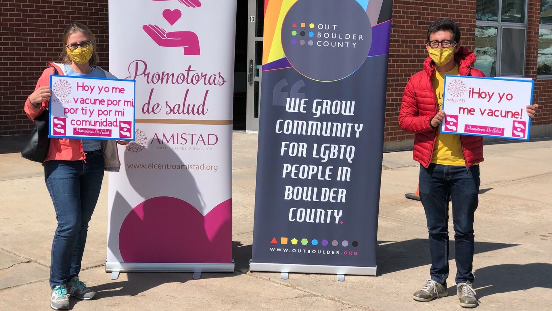 Two people standing in front of an equity vaccine clinic in Colorado.